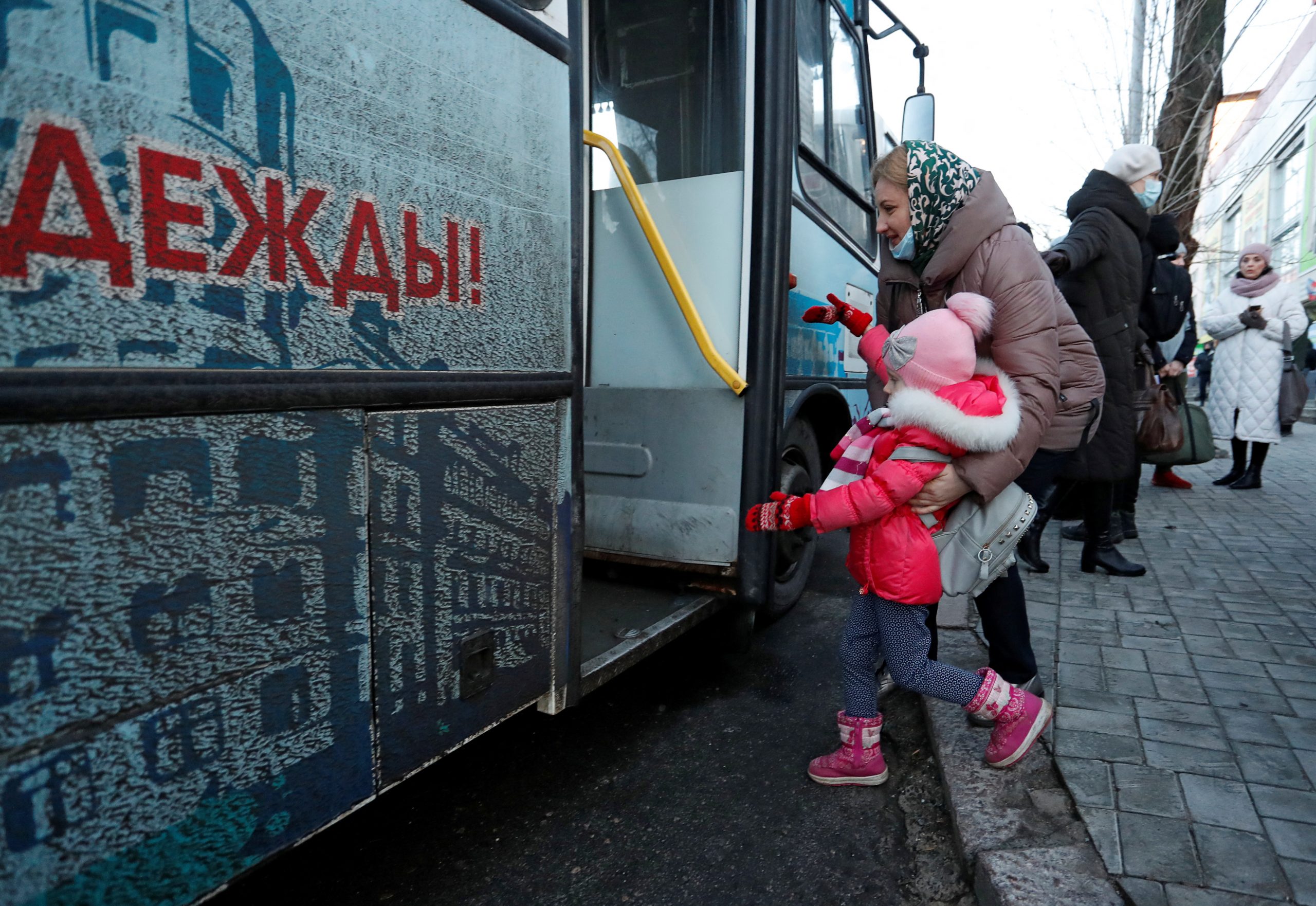 People board a bus during the evacuation of local residents to Russia, in the rebel-controlled city of Donetsk, Ukraine February 19, 2022. REUTERS/Alexander Ermochenko