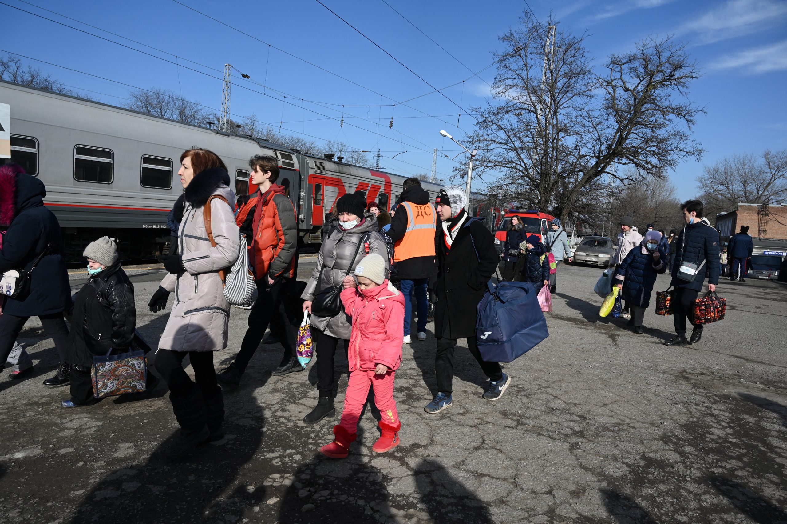 People, who were evacuated from separatist-controlled regions in eastern Ukraine, board a train before leaving the city of Taganrog in the Rostov region, Russia February 20, 2022. REUTERS/Sergey Pivovarov