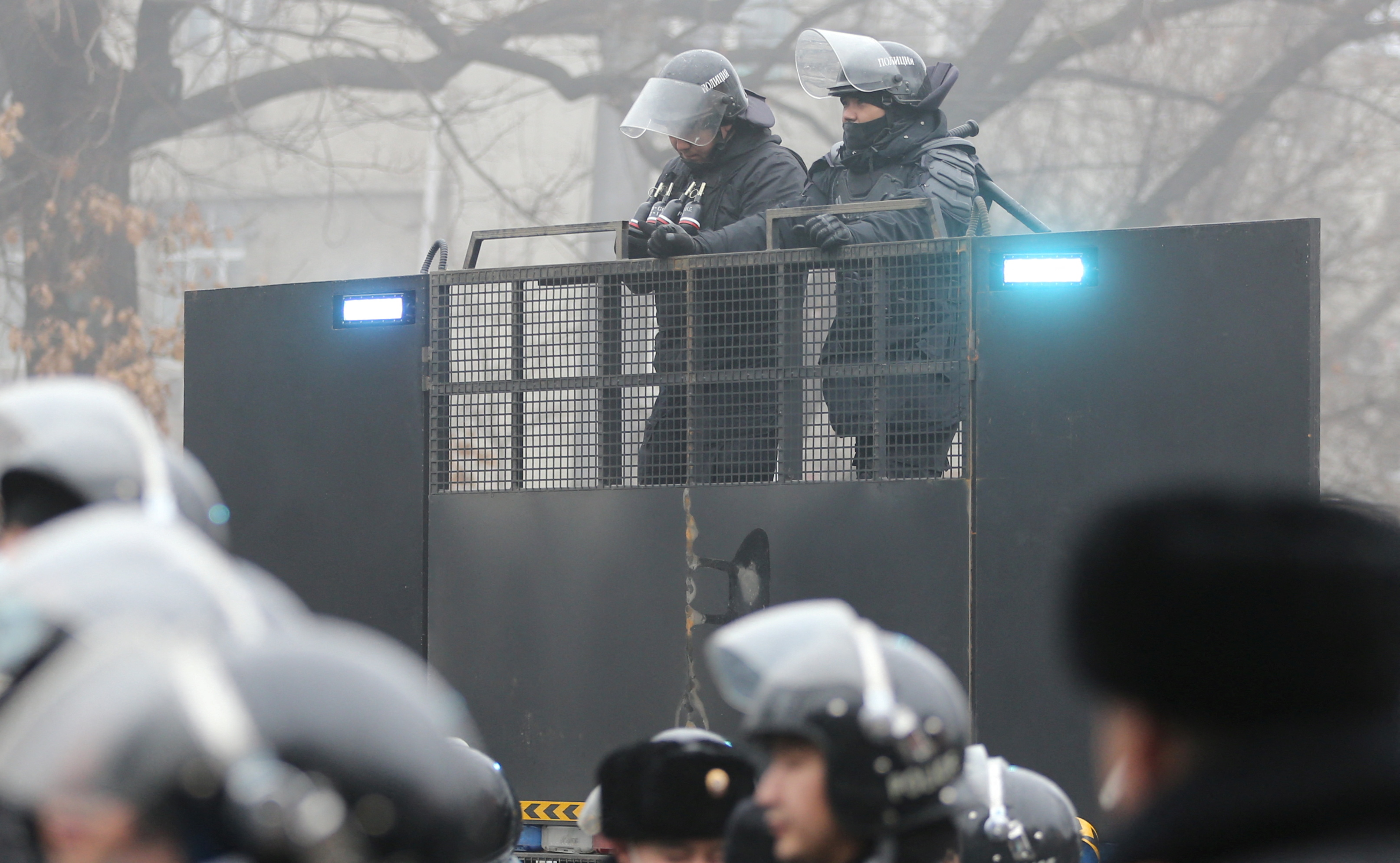 Kazahstan, protest
Kazakh law enforcement officers are seen on a barricade during a protest triggered by fuel price increase in Almaty, Kazakhstan January 5, 2022. REUTERS/Pavel Mikheyev