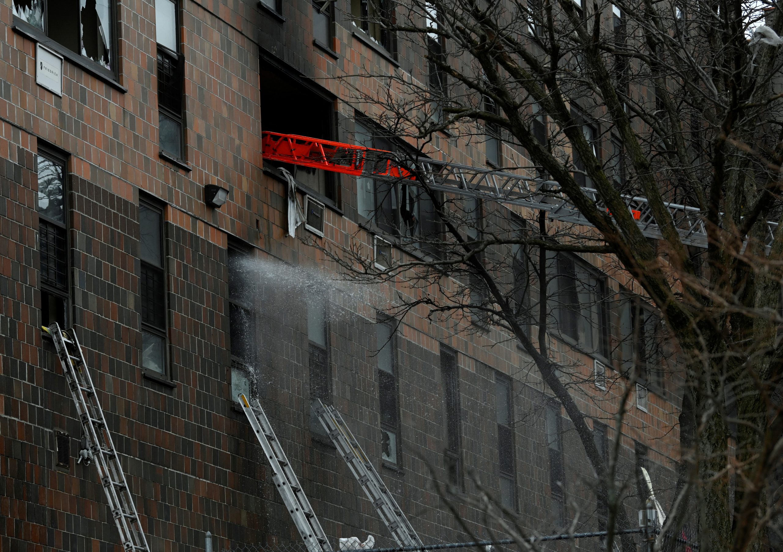 Emergency personnel from the FDNY respond to an apartment building fire in the Bronx borough of New York City, U.S., January 9, 2022.  REUTERS/Lloyd Mitchell