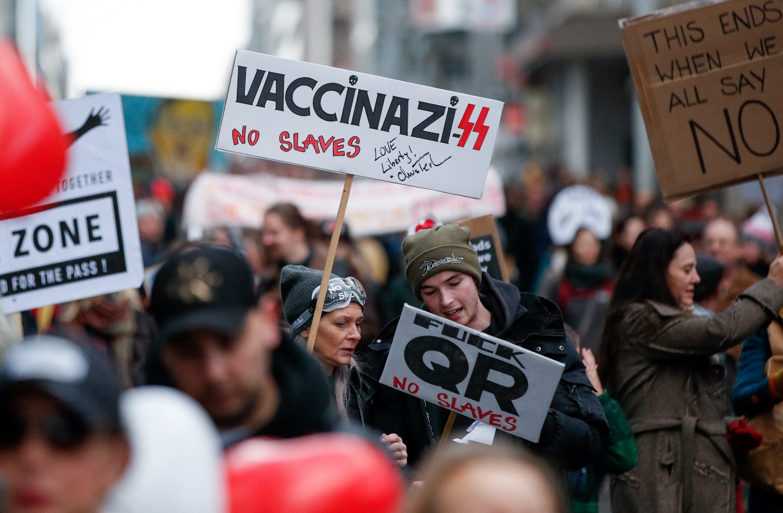 People interact as they take part in a demonstration against the Belgian government's restrictions imposed to contain the spread of the coronavirus disease (COVID-19) in Brussels, Belgium, January 9, 2022. REUTERS/Johanna Geron