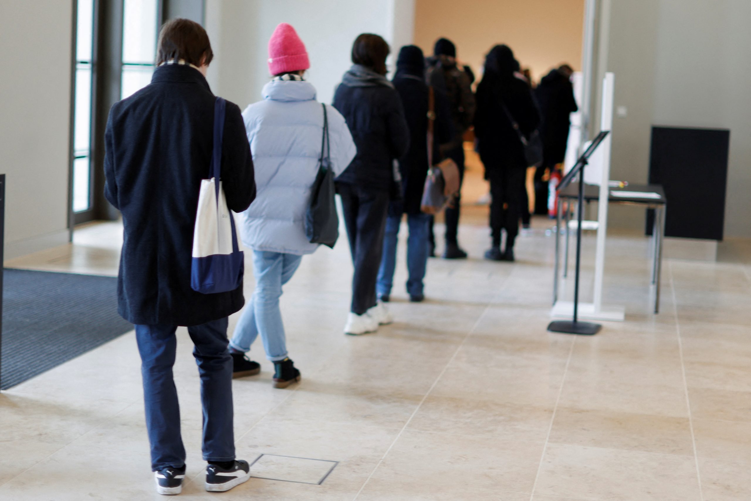 People wait in line to receive a shot of a coronavirus disease (COVID-19) vaccine at a vaccination center in the Humboldt Forum in Berlin, Germany January 19, 2022.  REUTERS/Michele Tantussi