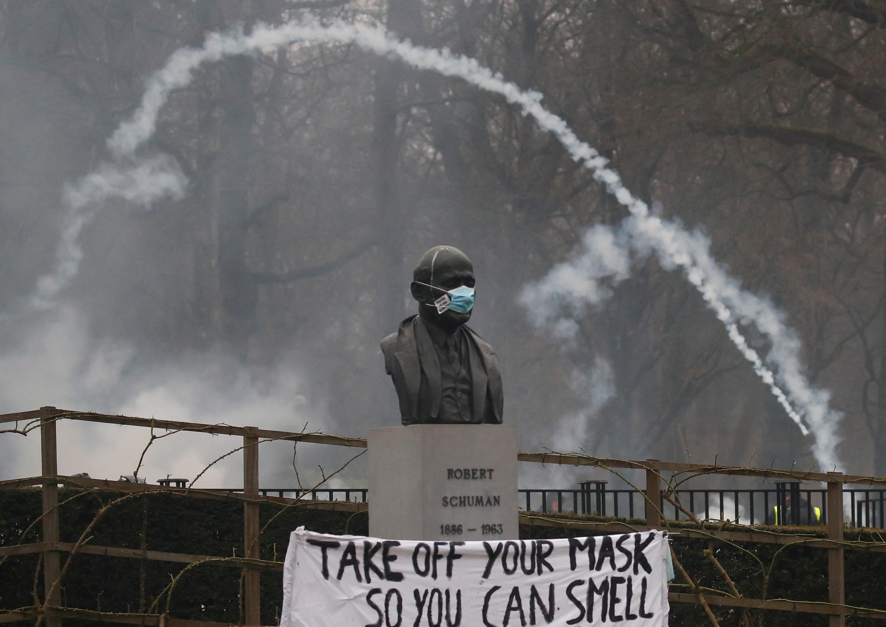 A masked statue with a banner is seen during a demonstration against the Belgian government's restrictions imposed to contain the spread of the coronavirus disease (COVID-19) in Brussels, Belgium, January 23, 2022. REUTERS/Johanna Geron