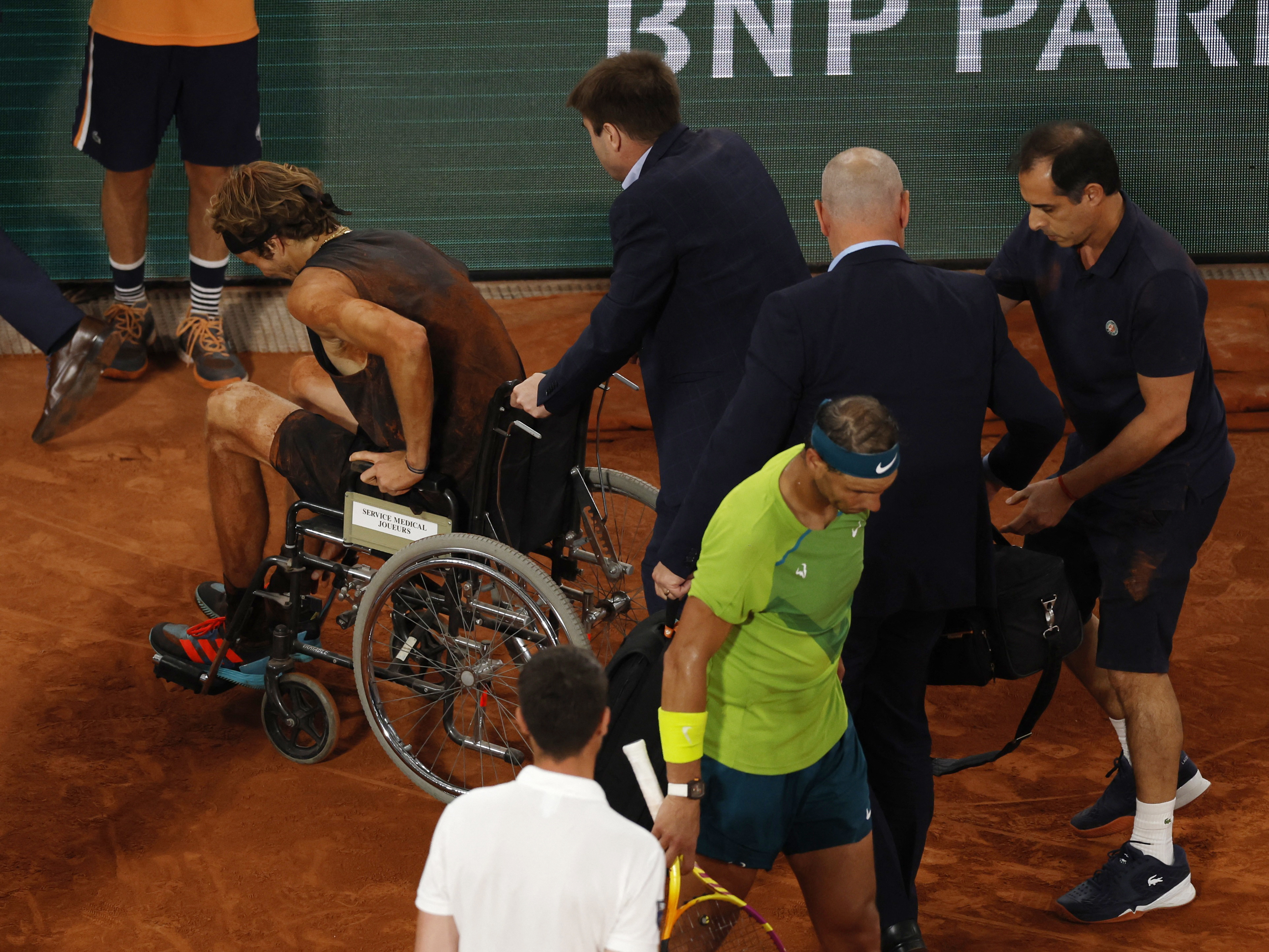 Tennis - French Open - Roland Garros, Paris, France - June 3, 2022 Germany's Alexander Zverev leaves the court after sustaining an injury REUTERS/Gonzalo Fuentes