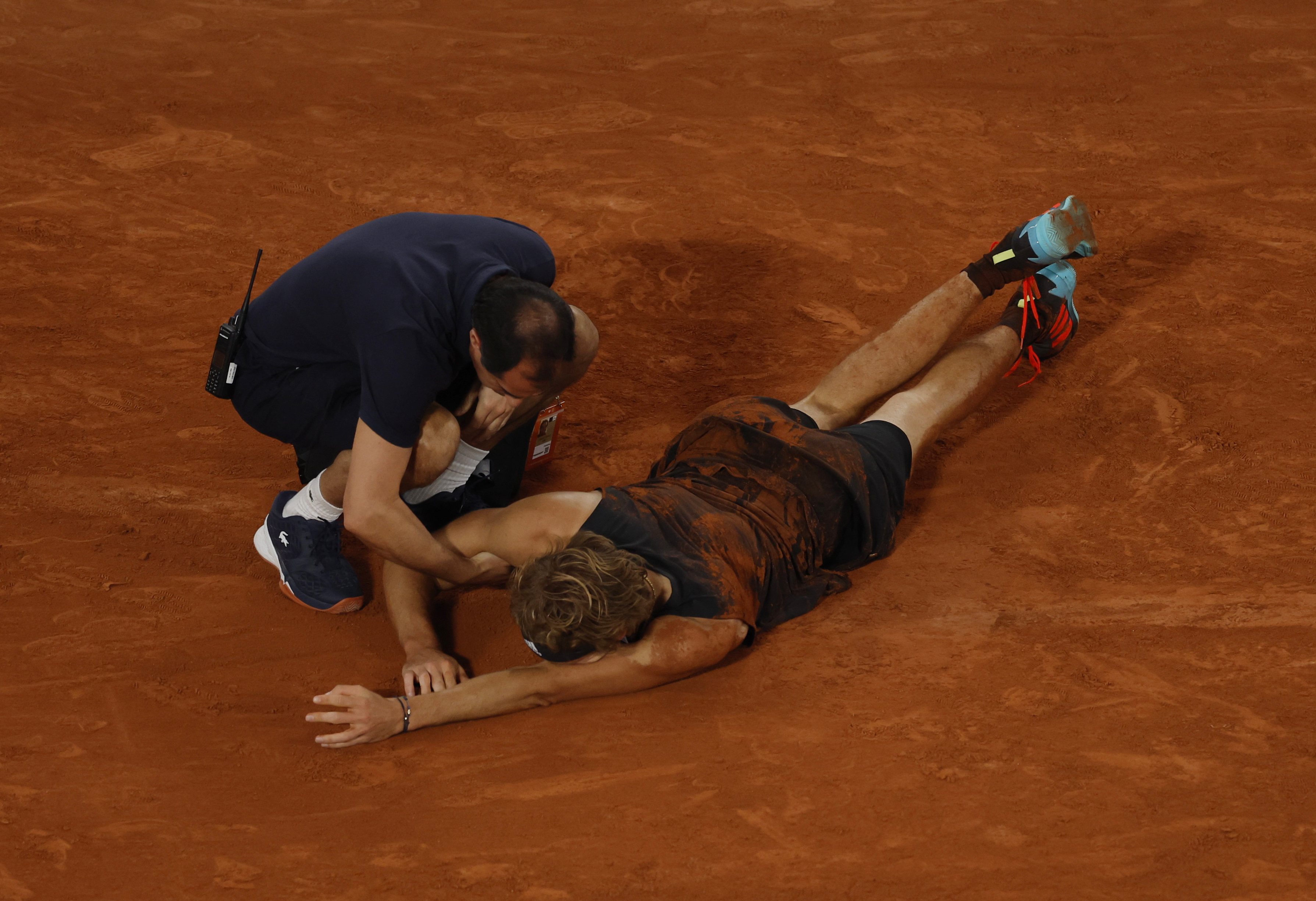 Tennis - French Open - Roland Garros, Paris, France - June 3, 2022 Germany's Alexander Zverev receives medical attention after sustaining an injury REUTERS/Gonzalo Fuentes