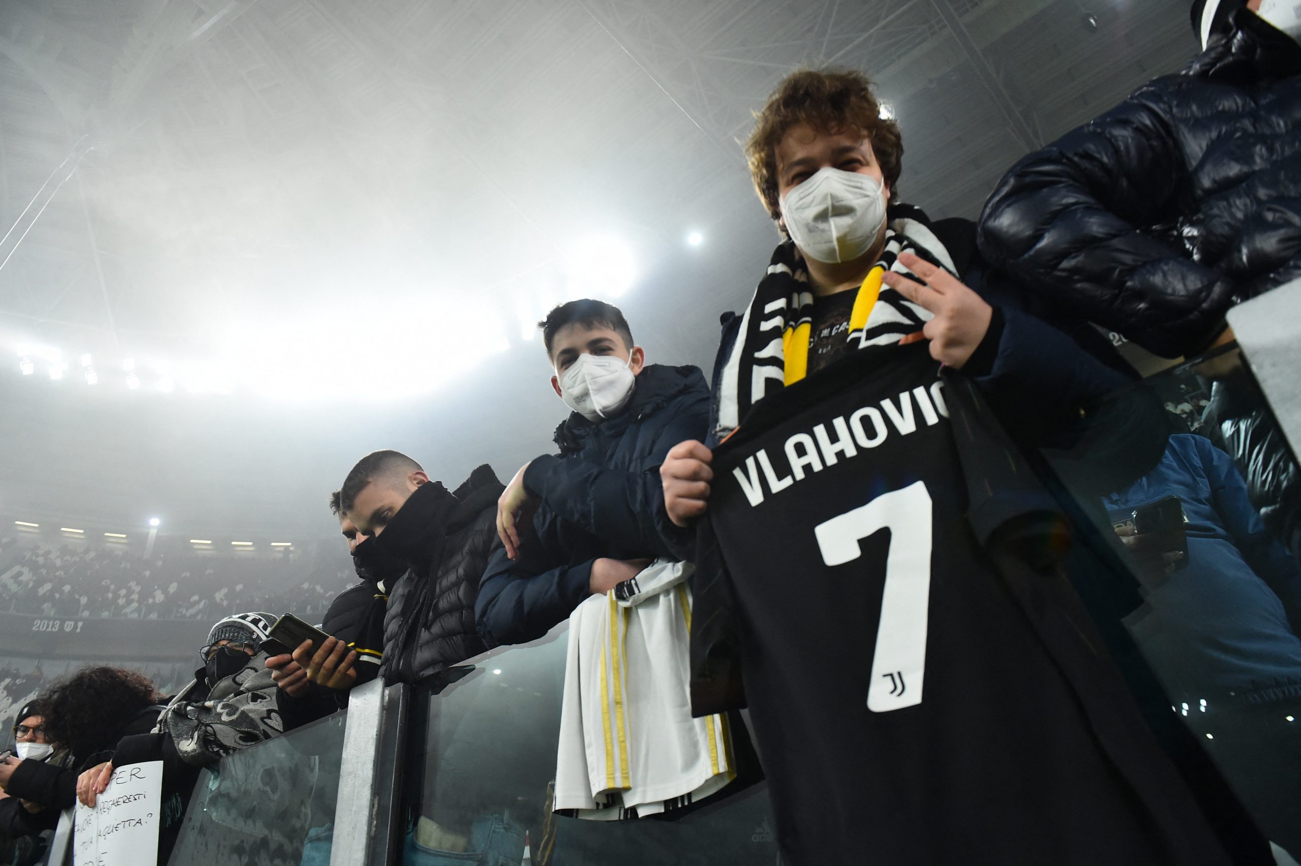 Soccer Football - Serie A - Juventus v Hellas Verona - Allianz Stadium, Turin, Italy - February 6, 2022 Juventus fans holding the shirt of Juventus' Dusan Vlahovic before the match REUTERS/Massimo Pinca