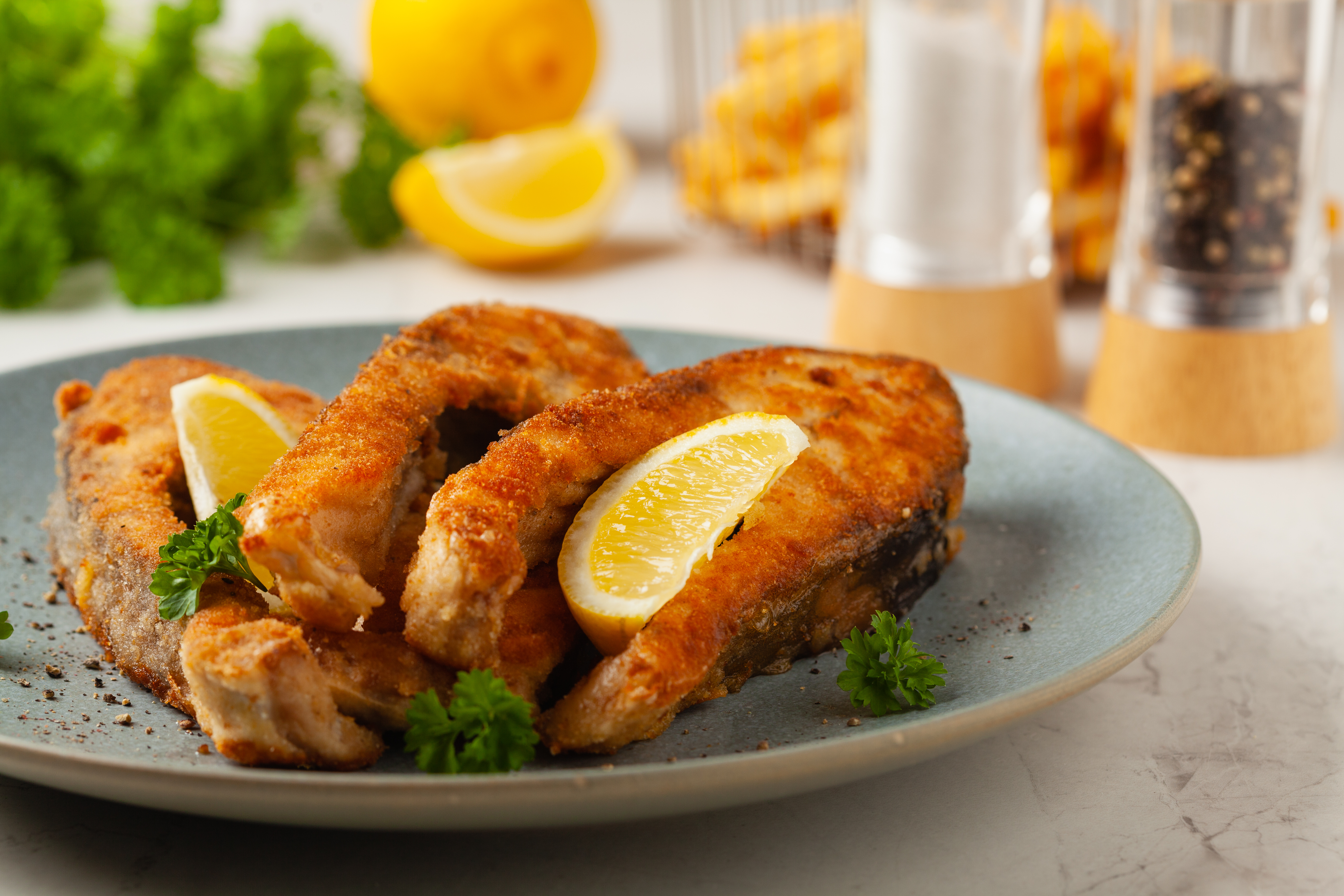 Fried,Carp,In,Pieces,,Served,On,A,Gray,Plate.,Marbled