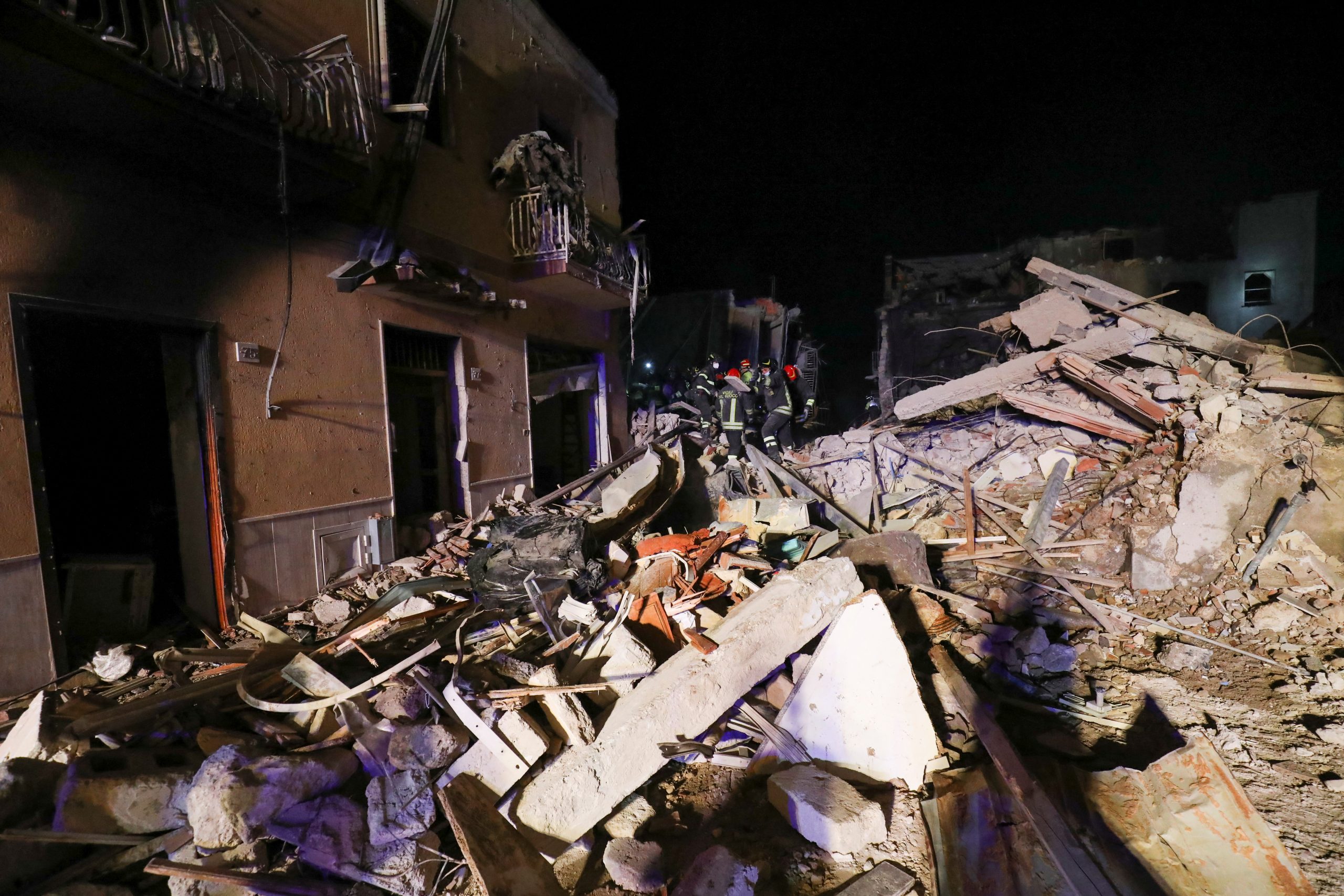 A rescue team searches for missing residents after a four-storey building collapsed following a gas explosion, in Ravanusa, Italy, December 12, 2021. REUTERS/Antonio Parrinello
