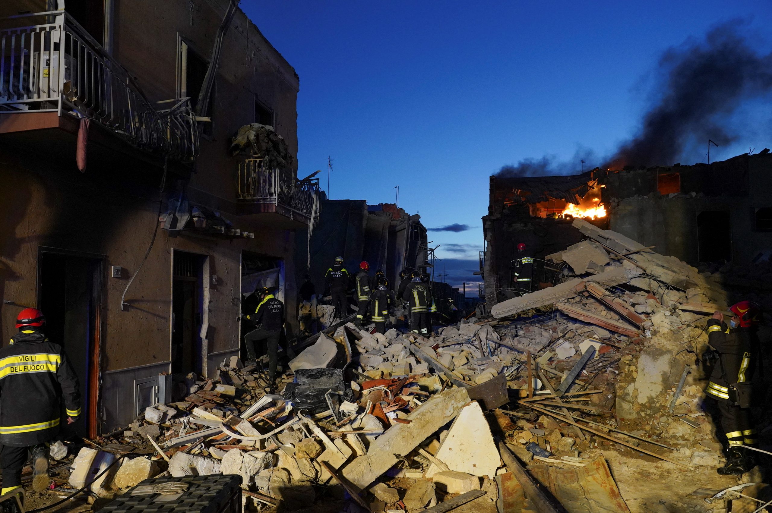Members of a rescue team work at the scene where a four-storey building collapsed following a gas explosion, in Ravanusa, Italy, December 12, 2021. REUTERS/Antonio Parrinello