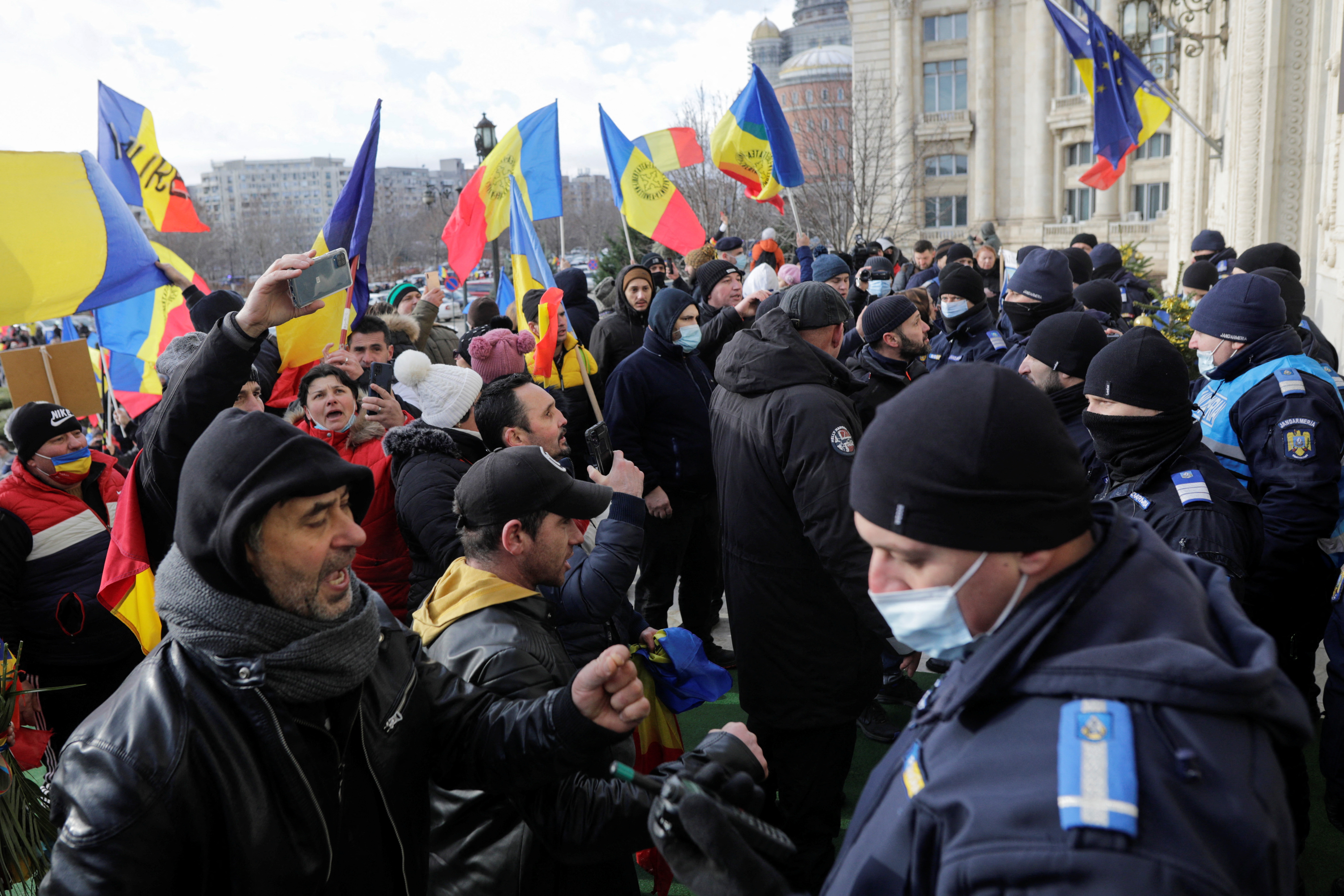 People attend protest against the introduction of COVID passes