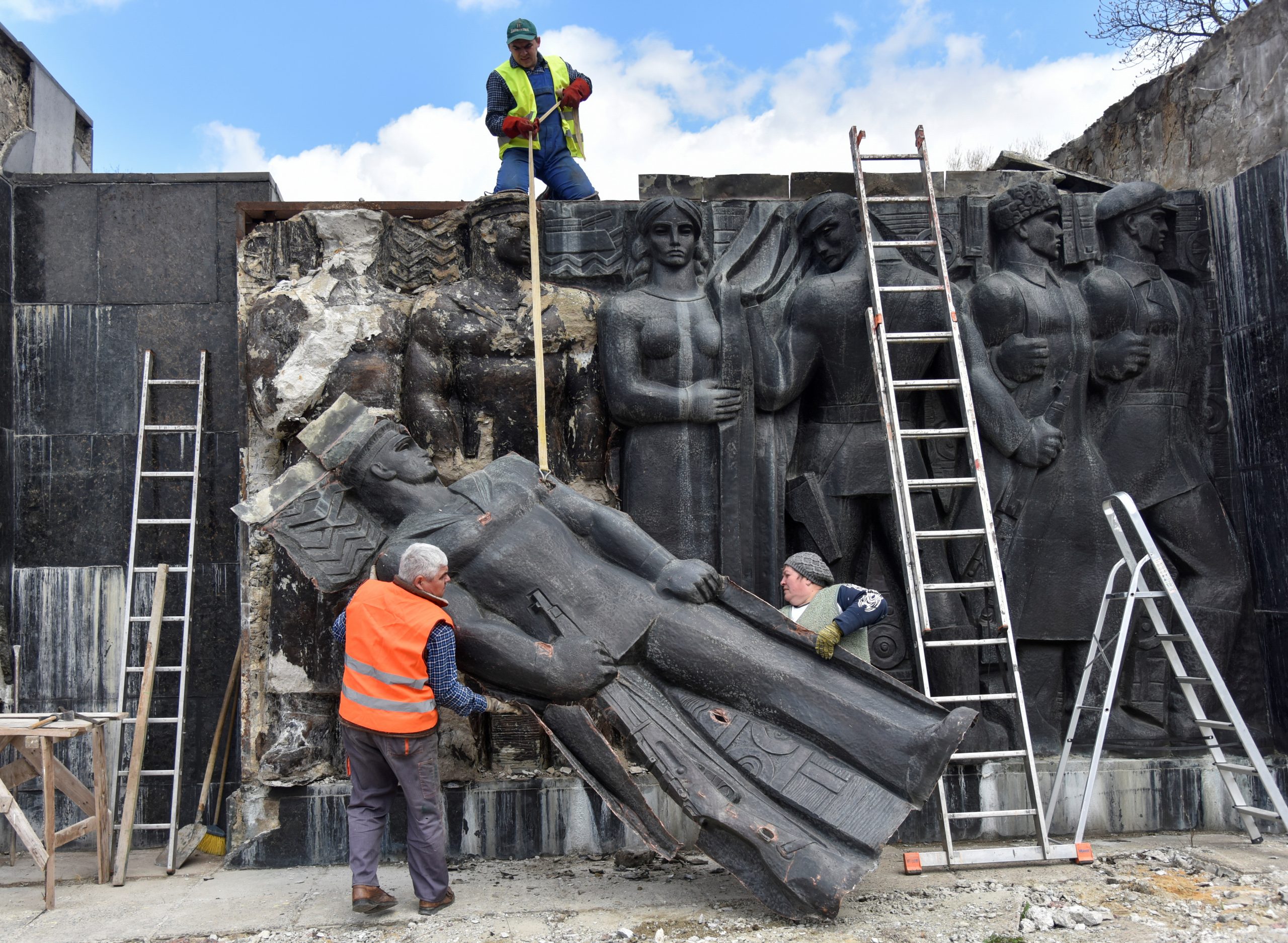 Workers dismantle bas-relief at the Monument to the War Glory of the Soviet Army following a decision by local authorities in Lviv, Ukraine April 23, 2021. REUTERS/Pavlo Palamarchuk