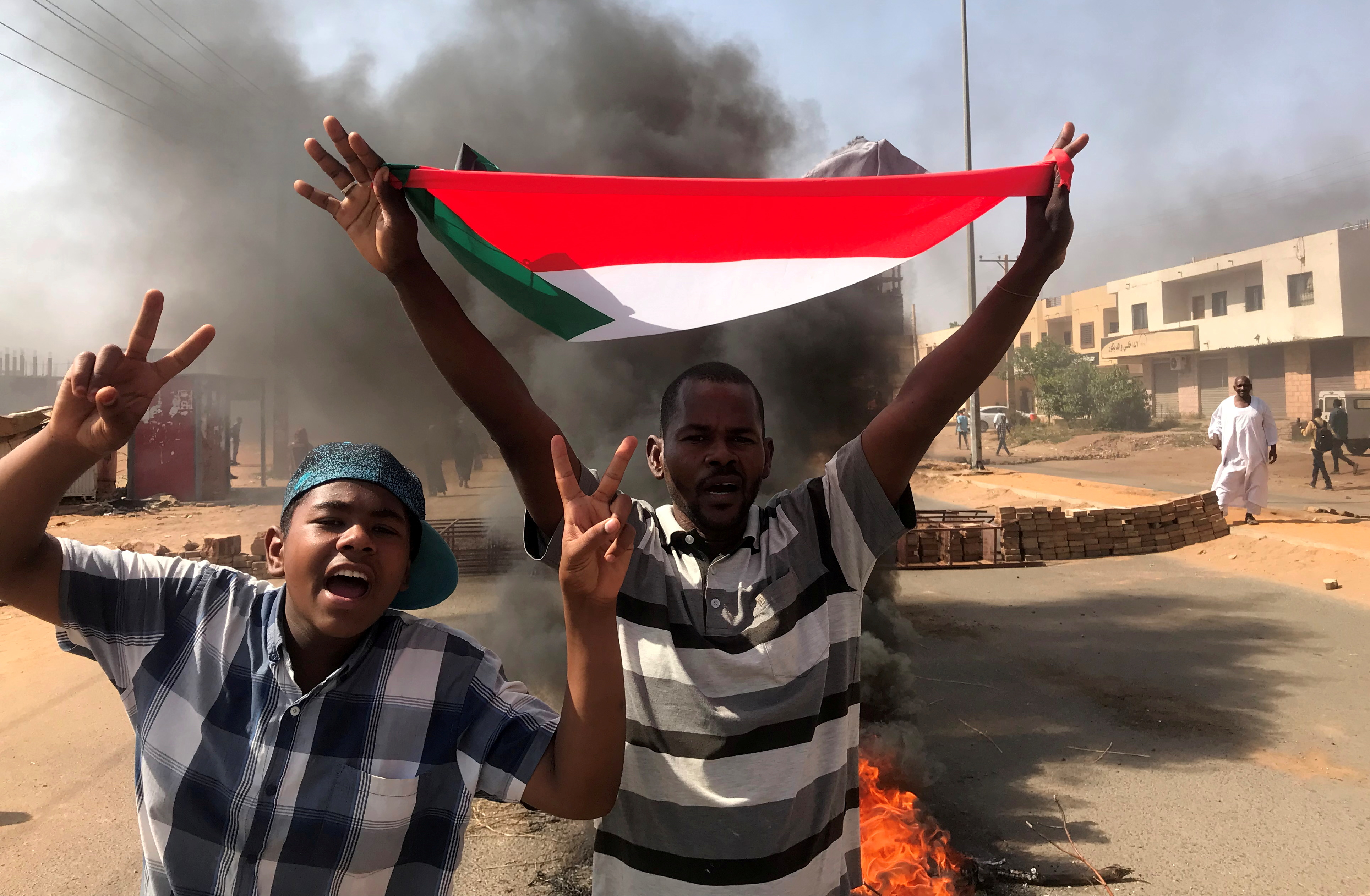 A protester waves a flag during what the information ministry calls a military coup in Khartoum, Sudan, October 25, 2021. REUTERS/Mohamed Nureldin Abdallah