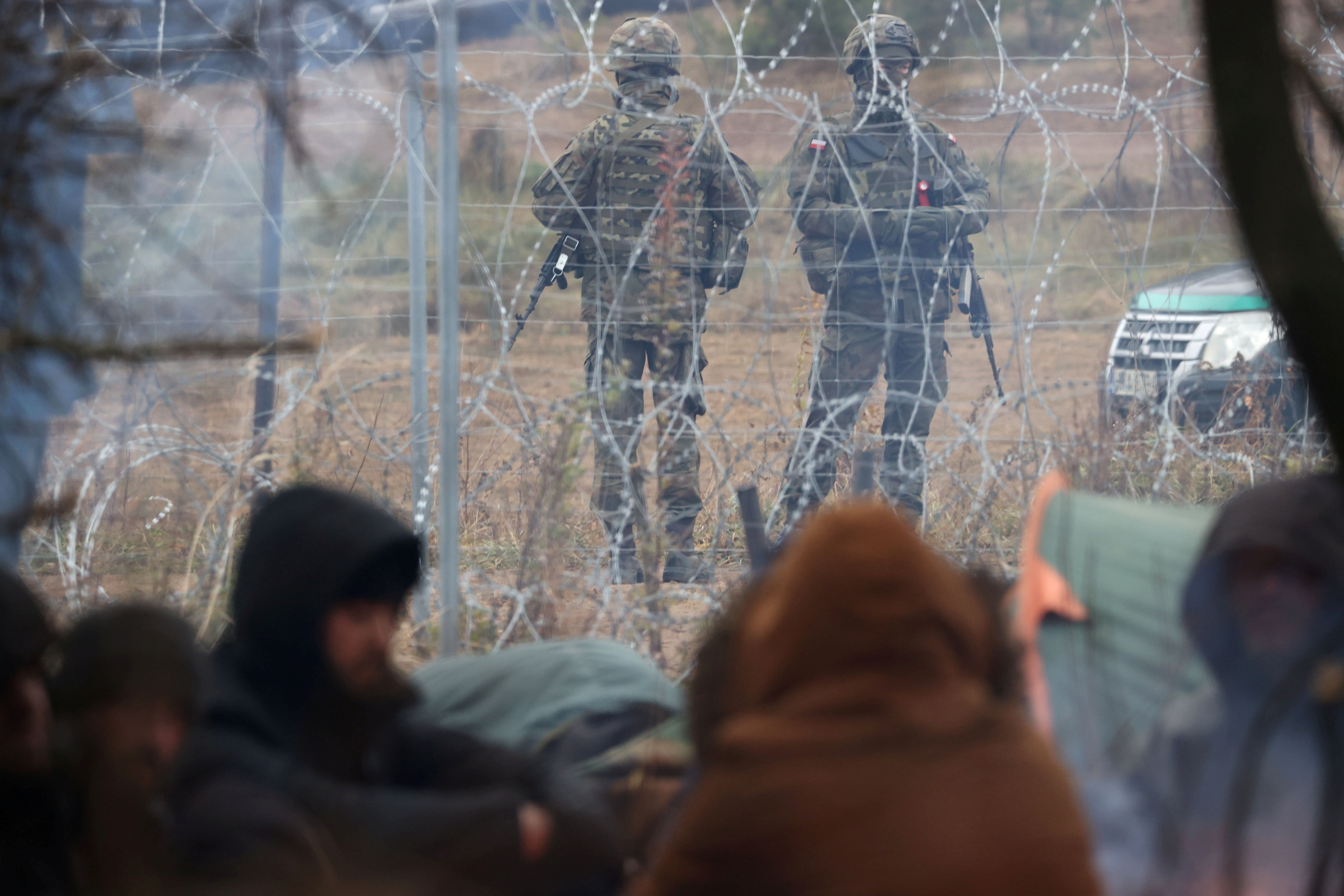 Migrants gather on the Belarusian-Polish border