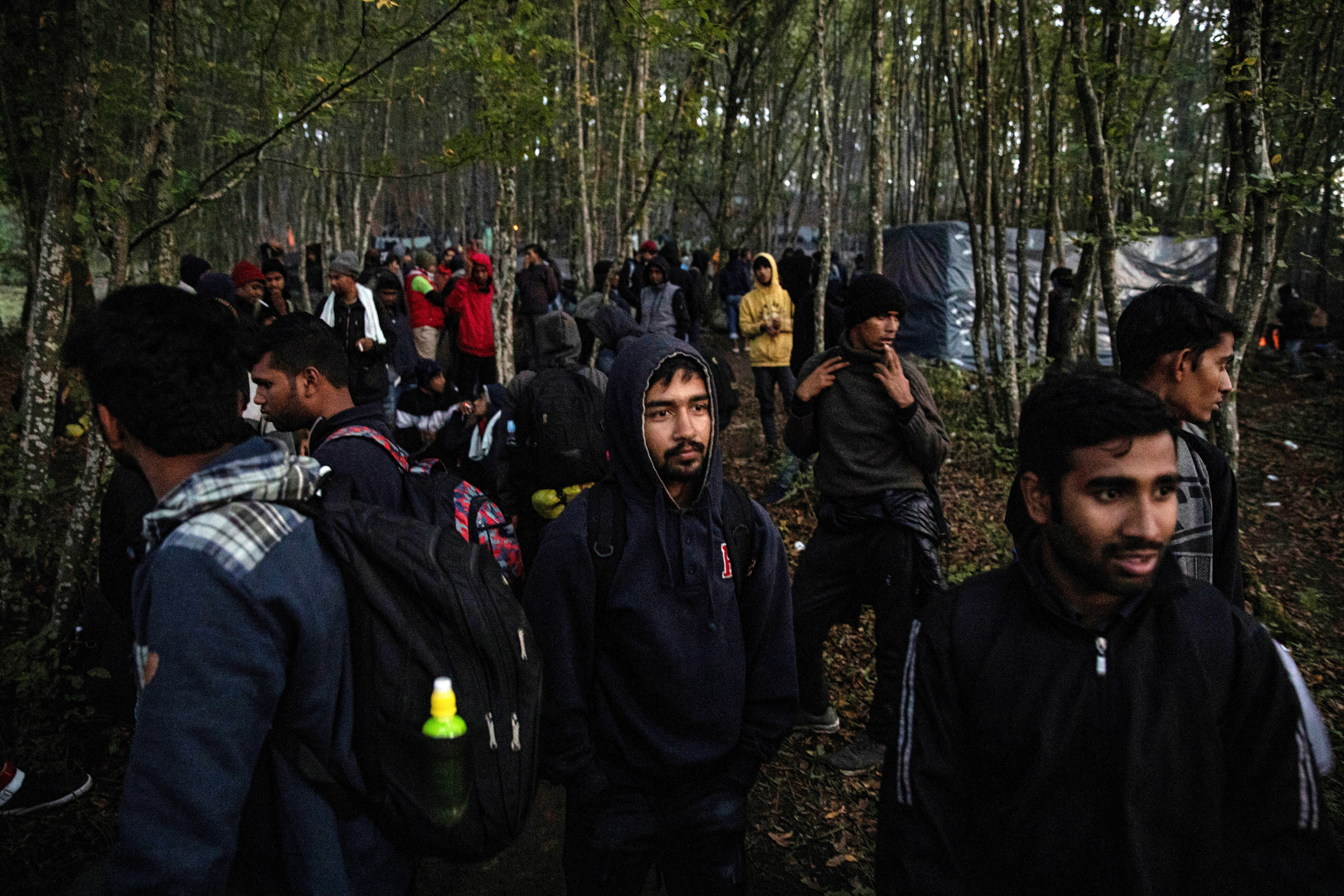 FILE PHOTO: Migrants gather before trying to cross the Bosnia-Croatia border near Velika Kladusa