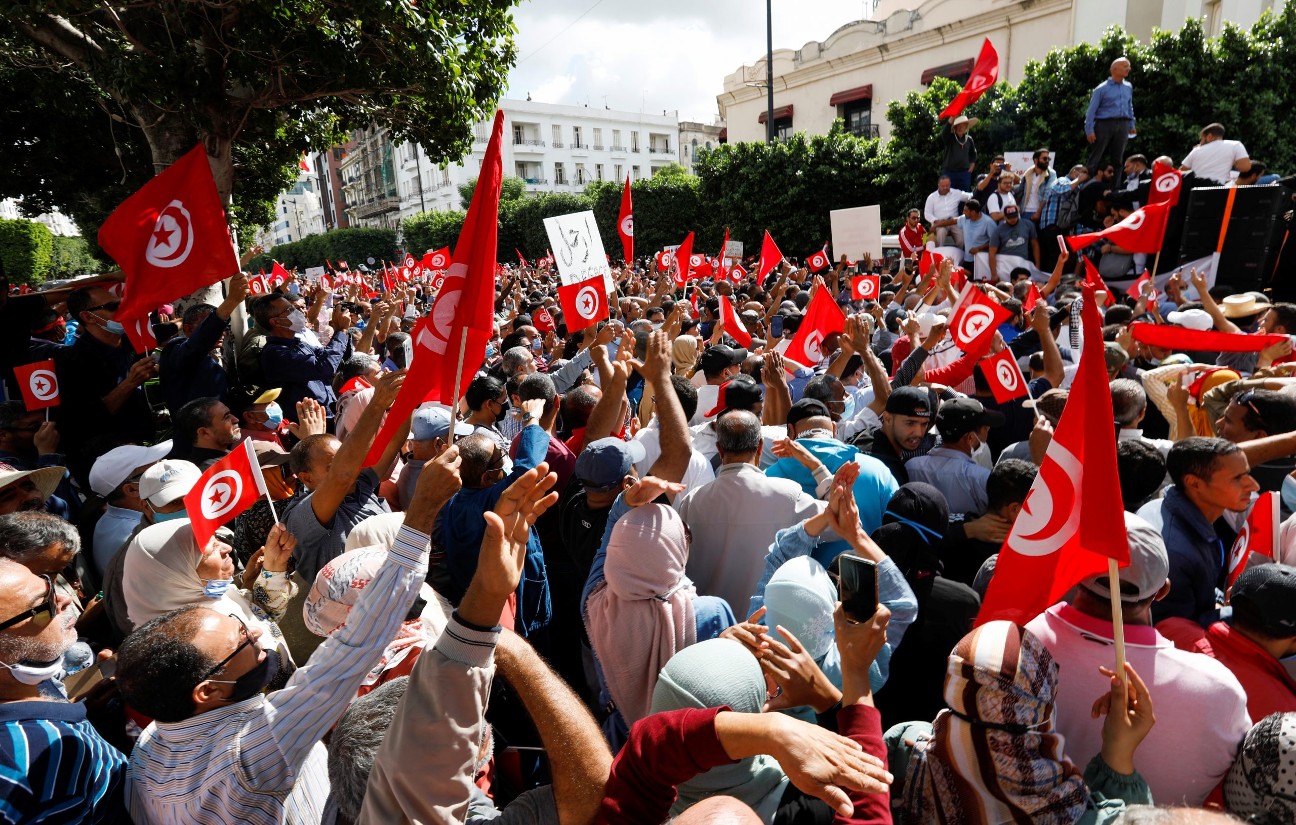 Demonstrators carry flags and banners during a protest against Tunisian President Kais Saied's seizure of governing powers, in Tunis, Tunisia, October 10, 2021. REUTERS/Zoubeir Souissi