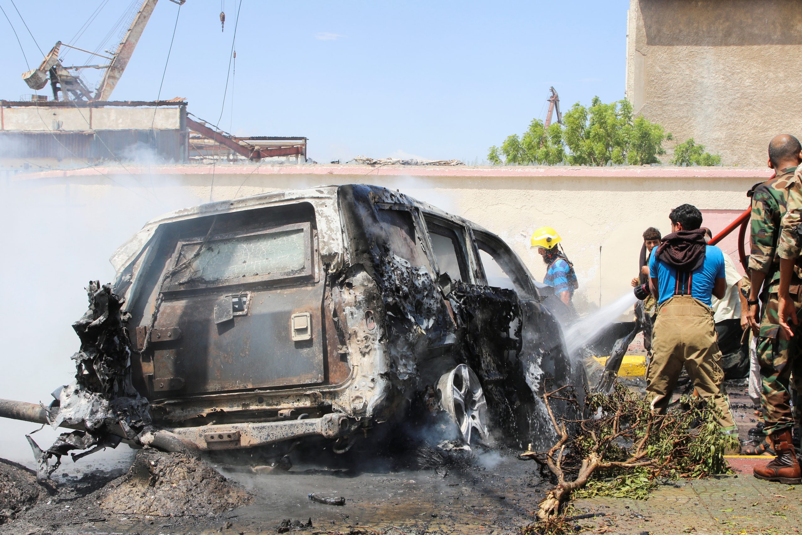 Firefighters and policemen work at the scene of a blast in Aden, Yemen, October 10, 2021. REUTERS/Fawaz Salman