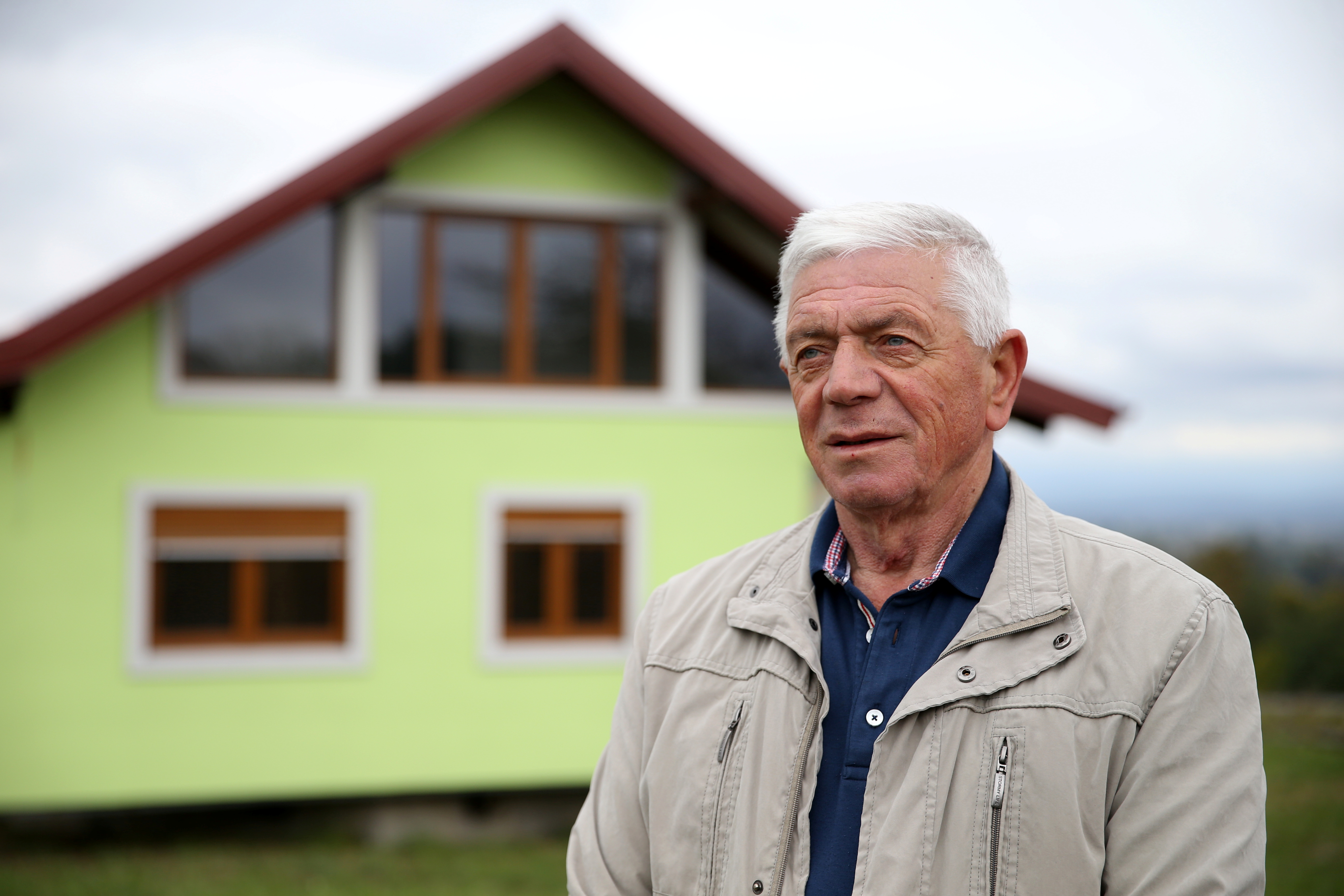 Vojin Kusic poses for photo in front of his rotating house in Srbac