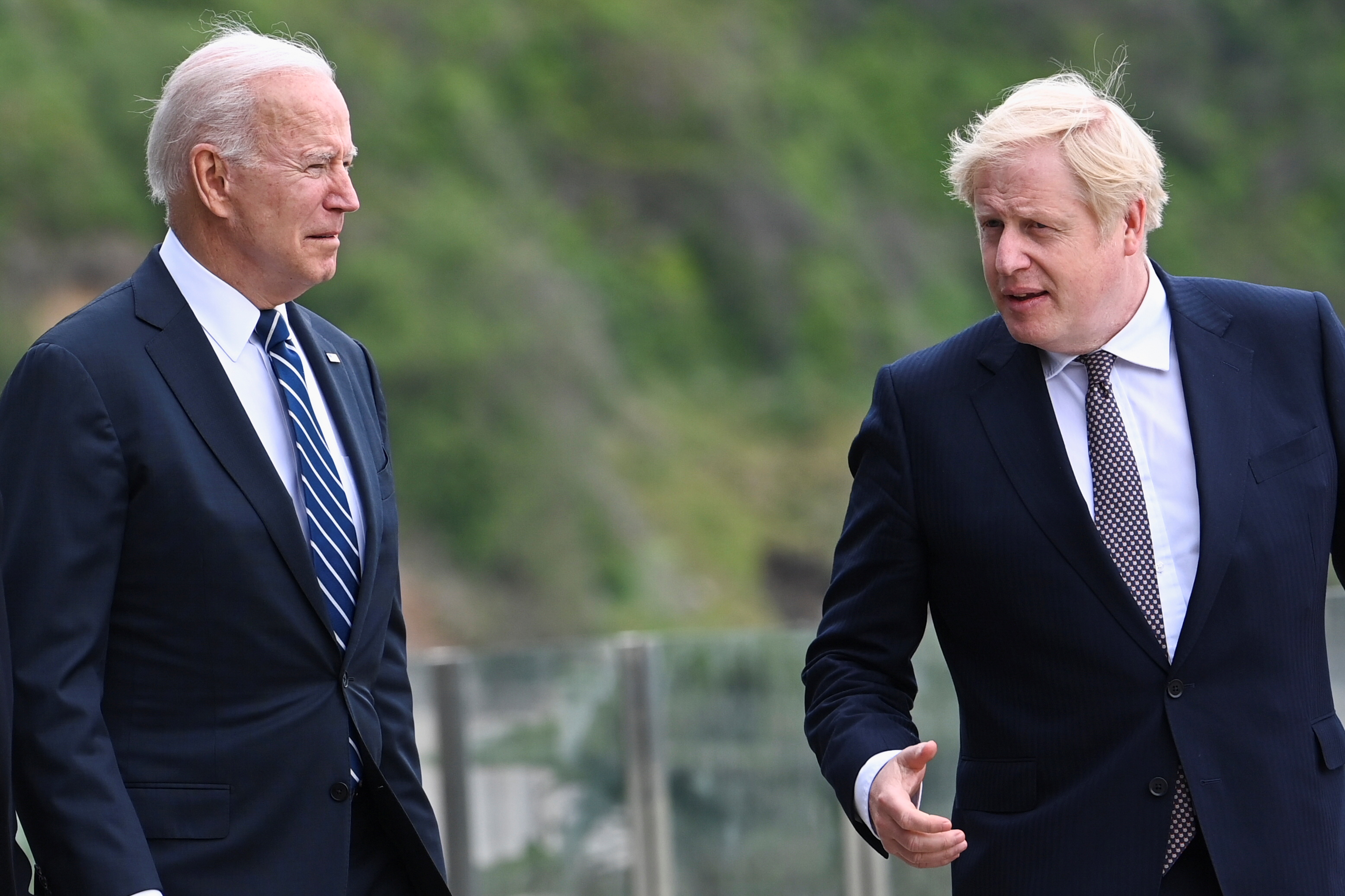 Britain's Prime Minister Boris Johnson speaks with U.S. President Joe Biden while they walk outside Carbis Bay Hotel, Carbis Bay, Cornwall, Britain June 10, 2021. REUTERS/Toby Melville/Pool