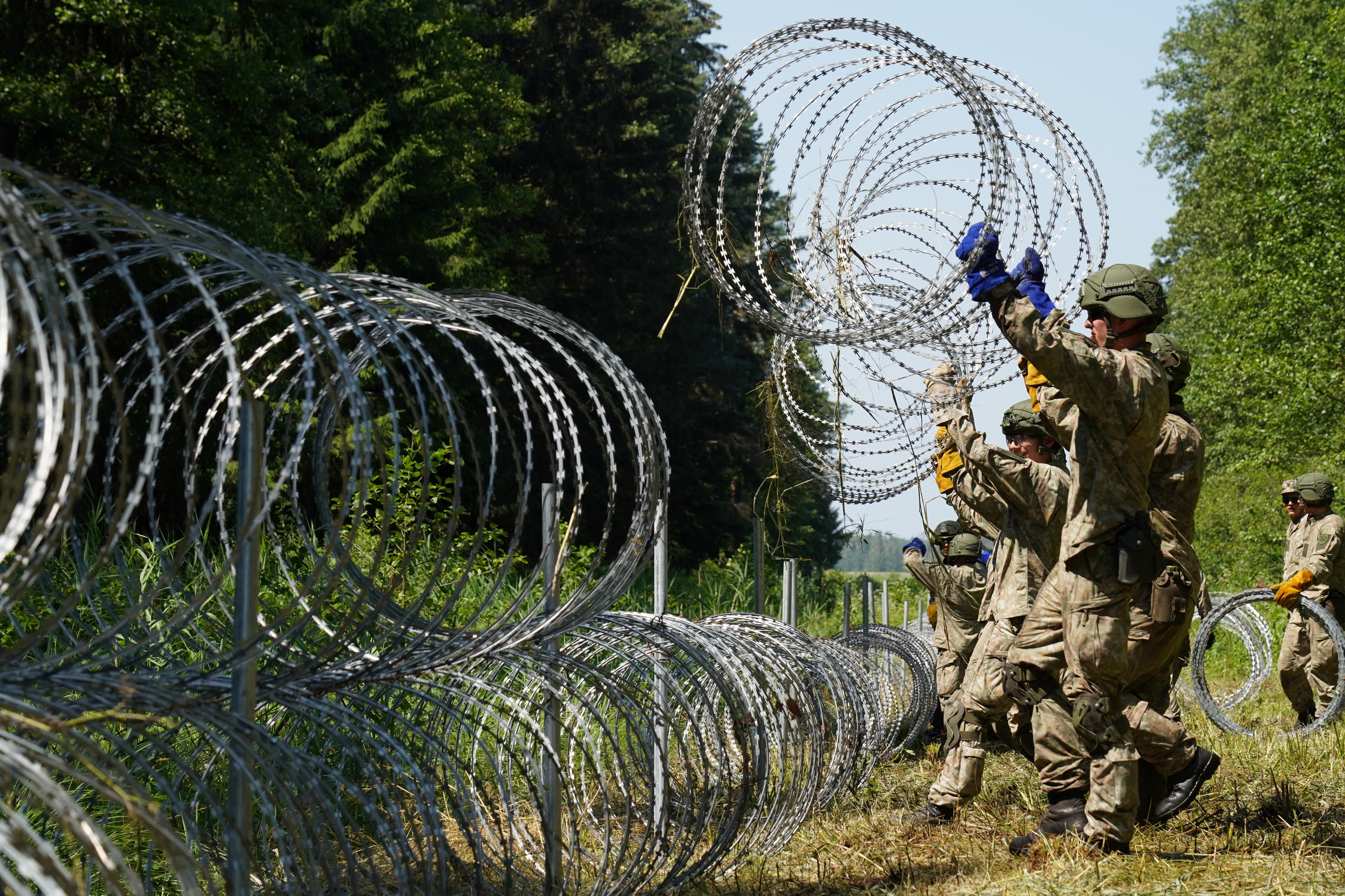 Lithuania toughens Belarus border with razor wire to bar migrants