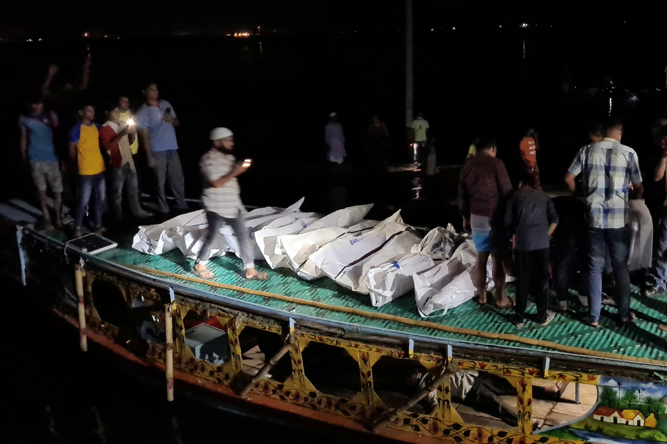 Recovered bodies are seen after a boat packed with passengers slammed into a vessel transporting sand, in Brahmanbaria, Bangladesh August 27, 2021. REUTERS/Stringer NO RESALES. NO ARCHIVES