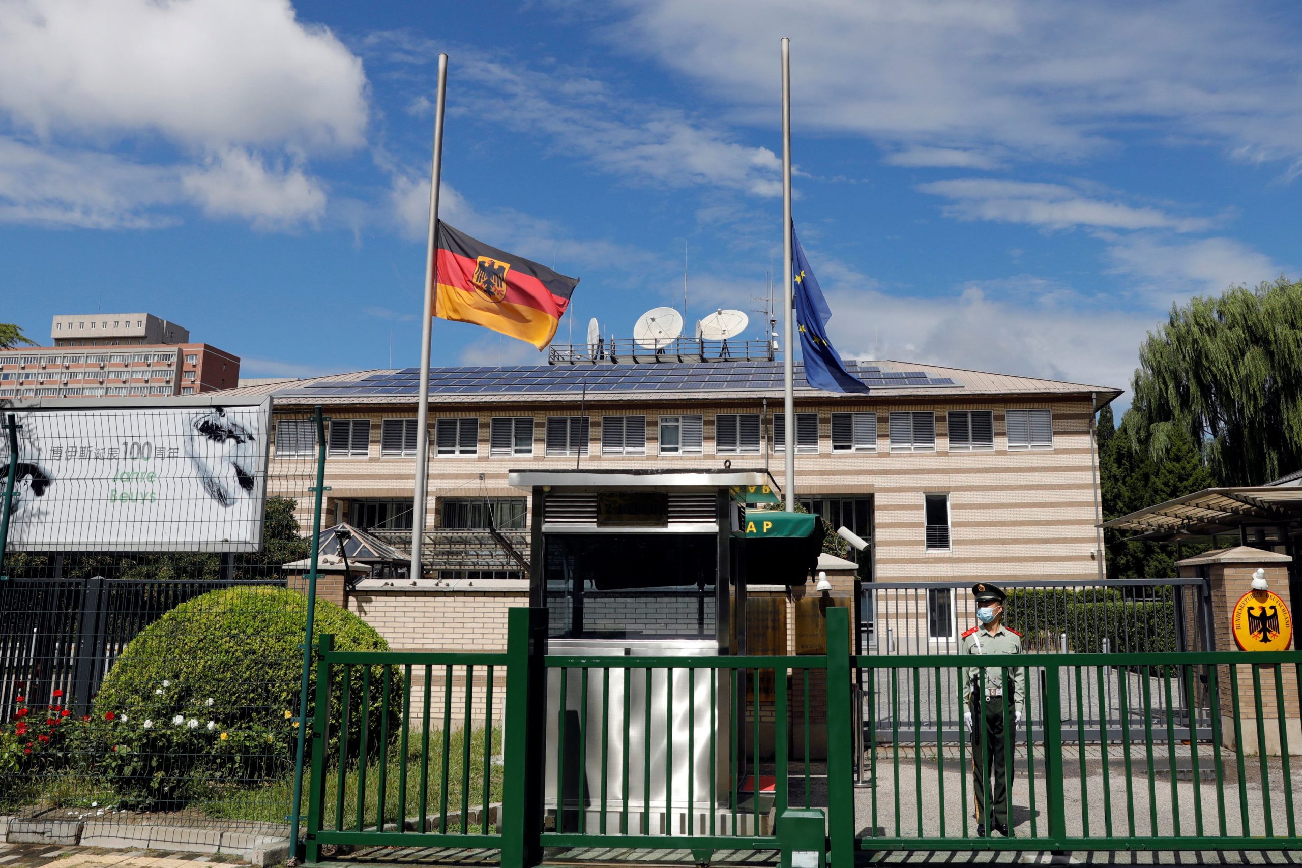 The German and European Union flags fly at half mast after German ambassador to China Jan Hecker passed away, at the Germany embassy in Beijing, China September 6, 2021. REUTERS/Carlos Garcia Rawlins