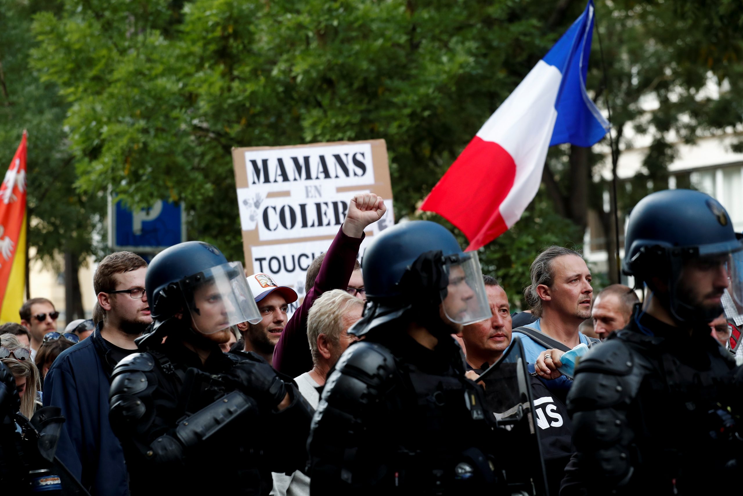 Protesters attend a demonstration against France's restrictions, including compulsory health passes, to fight the coronavirus disease (COVID-19) pandemic, in Paris, France, September 11, 2021. REUTERS/Benoit Tessier