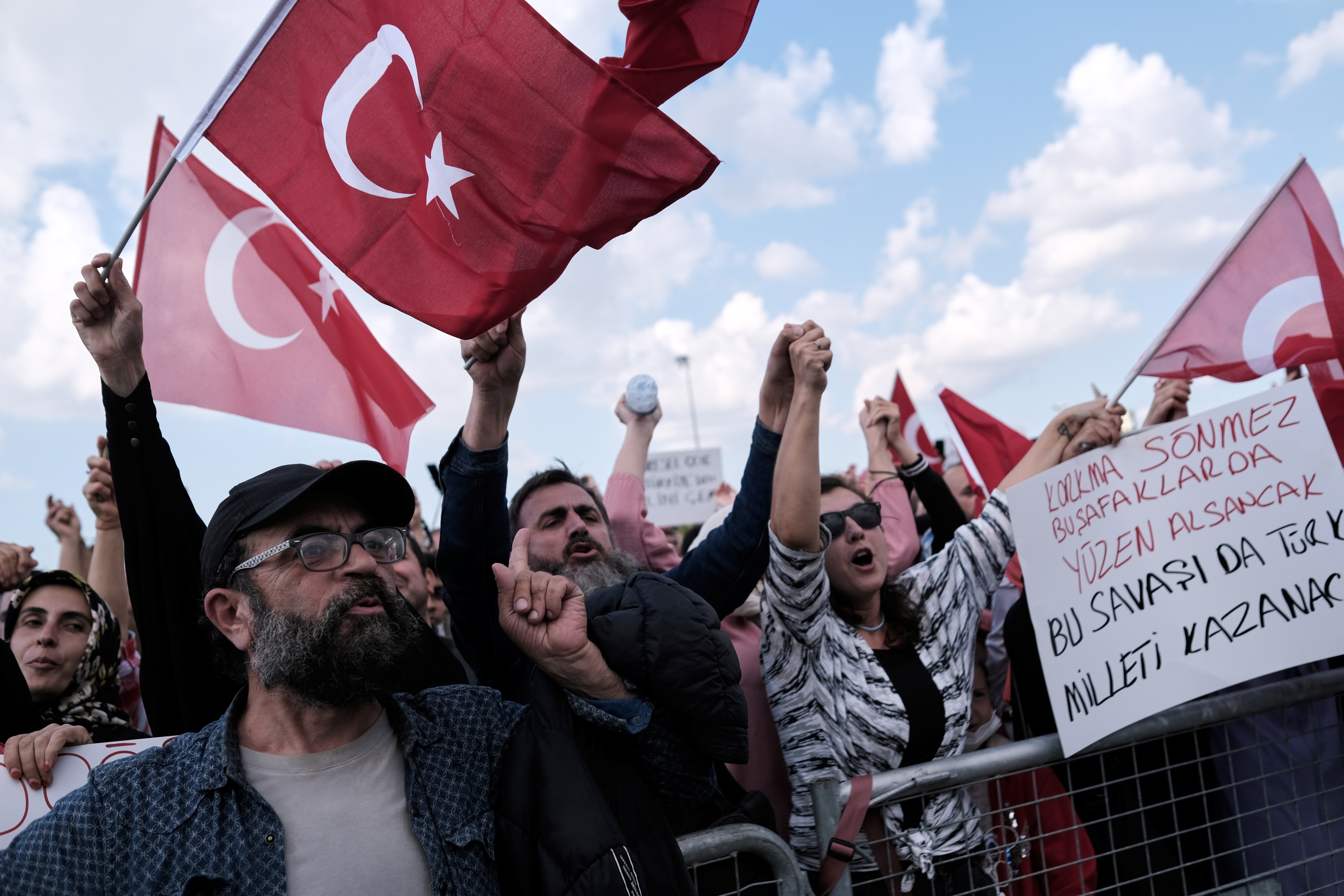 Demonstrators wave Turkish flags as they shout slogans during a protest against official coronavirus disease (COVID-19)-related mandates, including vaccinations, tests and masks, in Istanbul, Turkey September 11, 2021. REUTERS/Murad Sezer