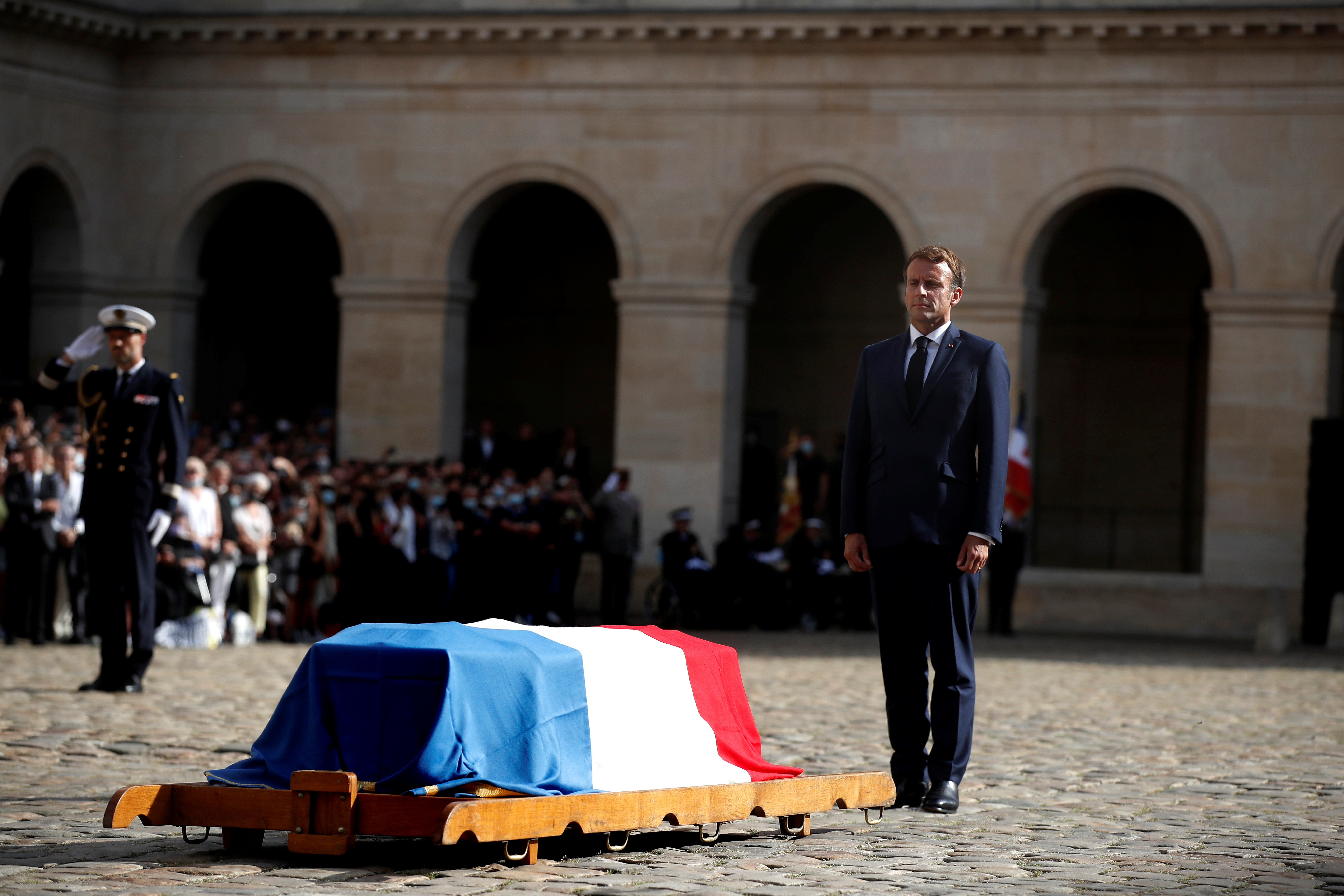 French President Emmanuel Macron stands in front of the coffin of late French actor Jean-Paul Belmondo, at the Hotel des Invalides in Paris, France September 9, 2021. Ian Langsdon/Pool via REUTERS
