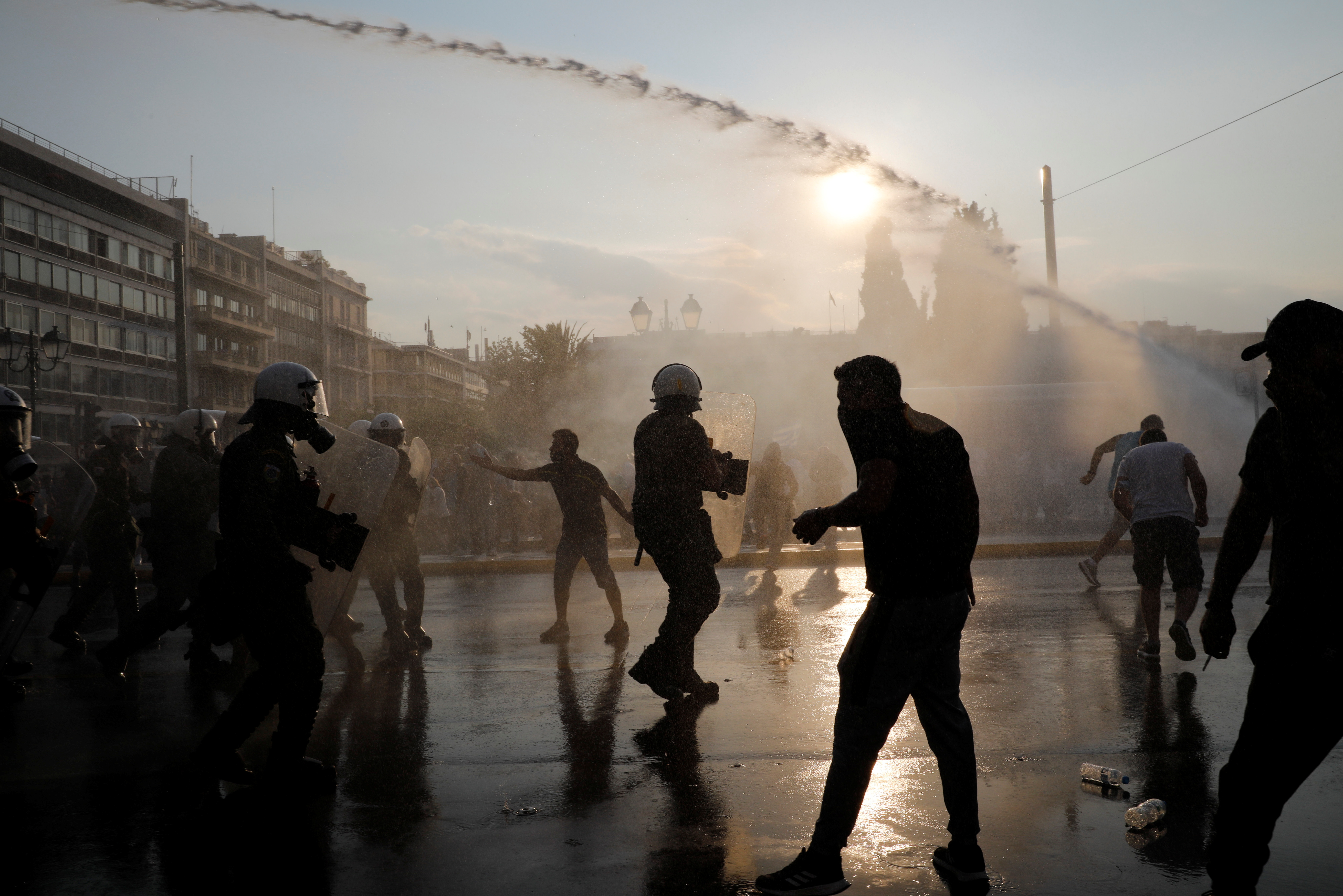 Police use water cannon against demonstrators during a protest against coronavirus disease (COVID-19) vaccinations outside the parliament building, in Athens, Greece, July 21, 2021. REUTERS/Costas Baltas