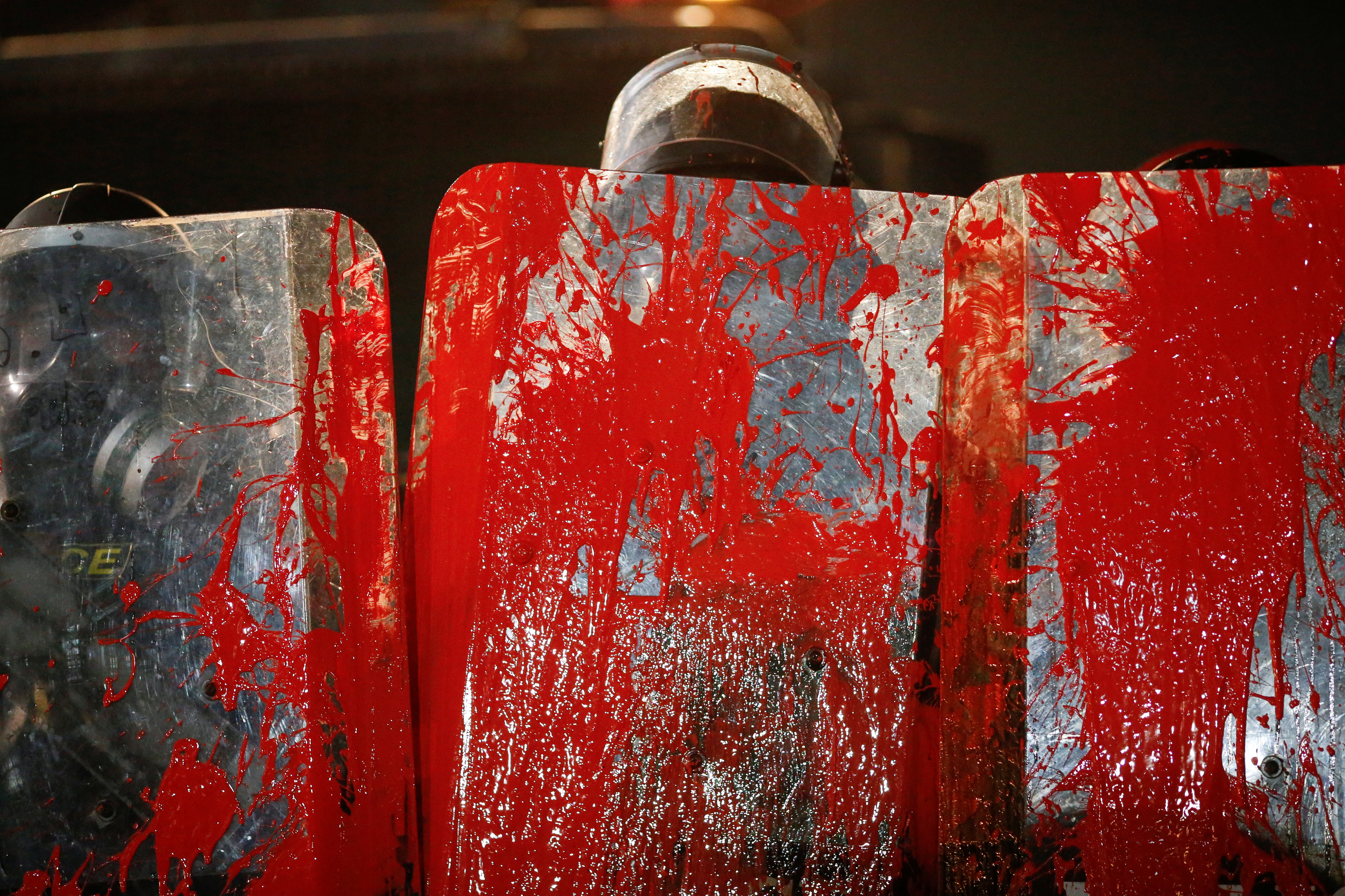 Shields of police officers are covered in red paint as pro-democracy demonstrators protest to demand the release of their leaders in Bangkok, Thailand, February 13, 2021. REUTERS/Soe Zeya Tun