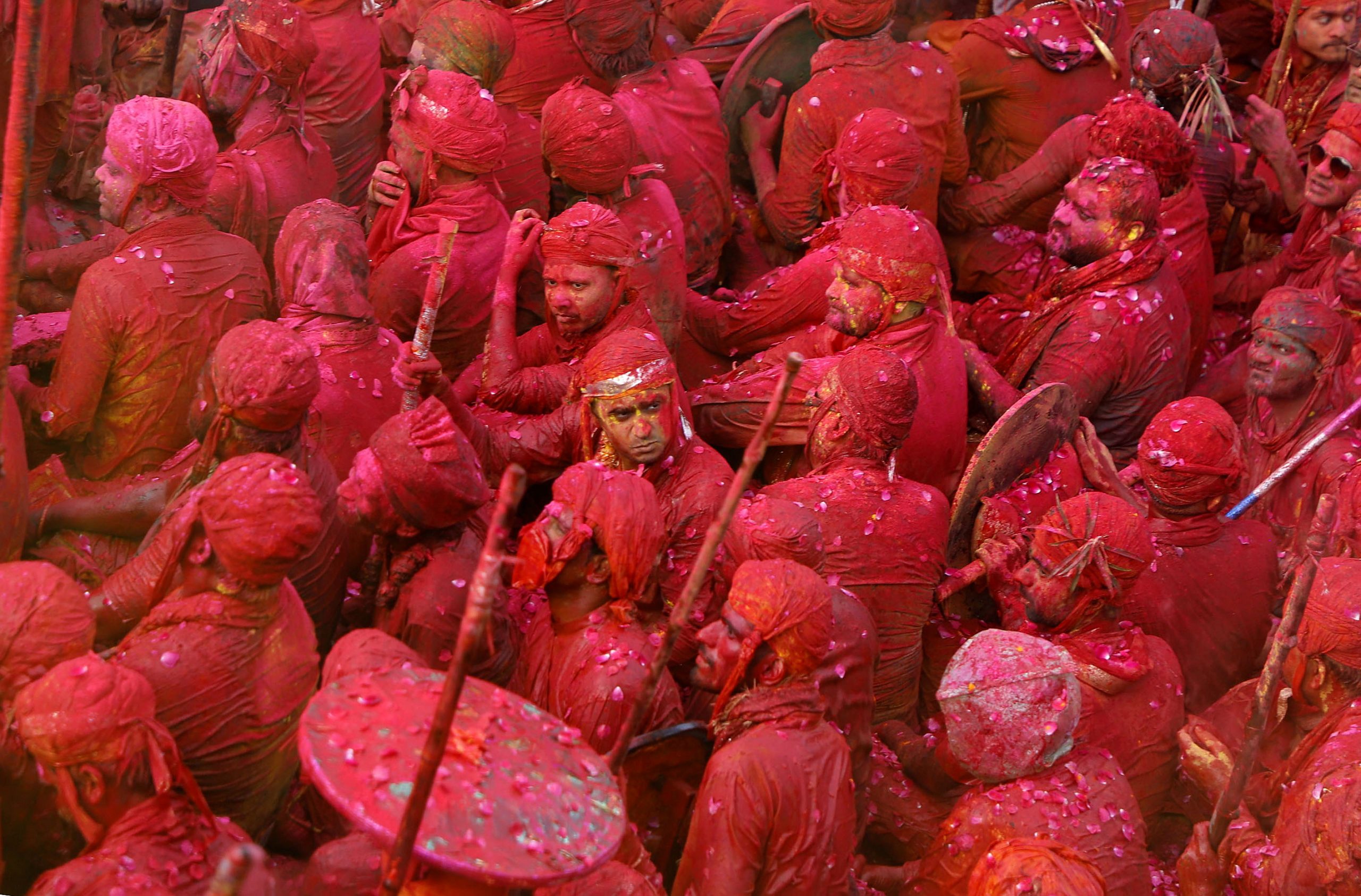 Men daubed in colours take part in Lathmar Holi celebrations, amidst the spread of the coronavirus disease (COVID-19), in the town of Nandgaon, in the northern state of Uttar Pradesh, India, March 24, 2021. REUTERS/K. K. Arora