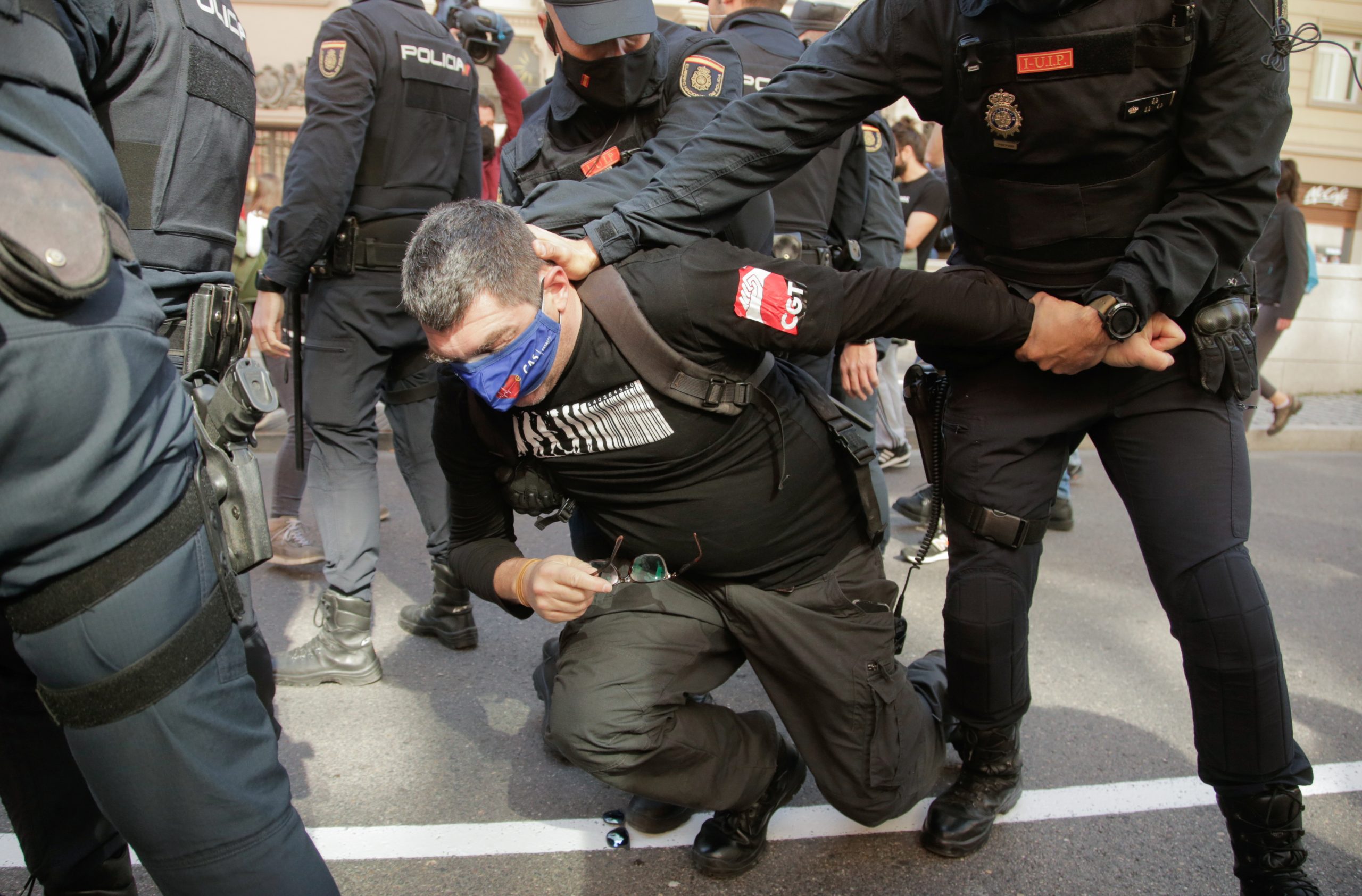 Police officers detain a man during a protest against the legislation which can bring partial privatisation of the public health sector in Madrid, Spain, February 27, 2021. REUTERS/Javier Barbancho