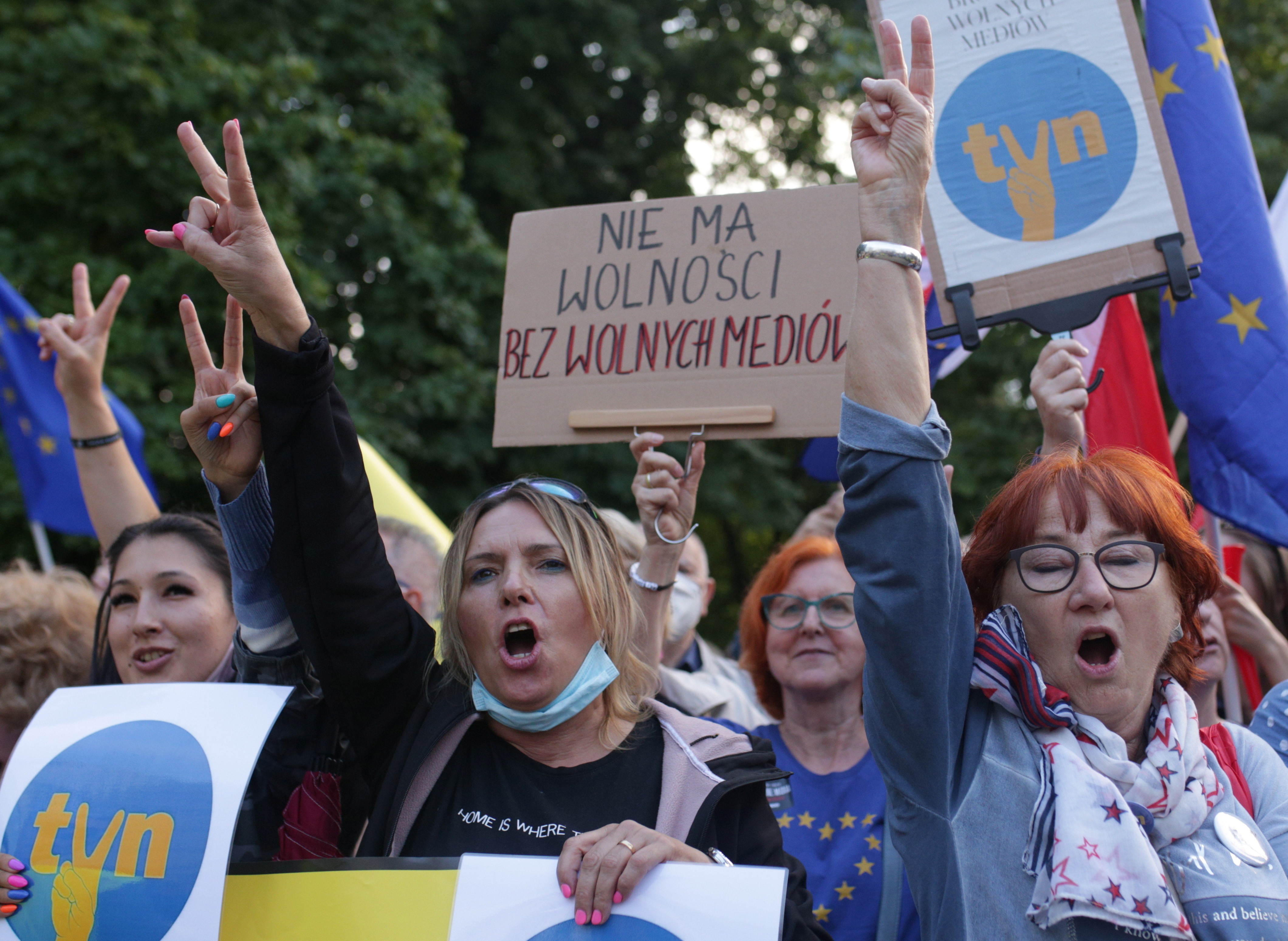 People attend a demonstration in defence of media freedom in Warsaw