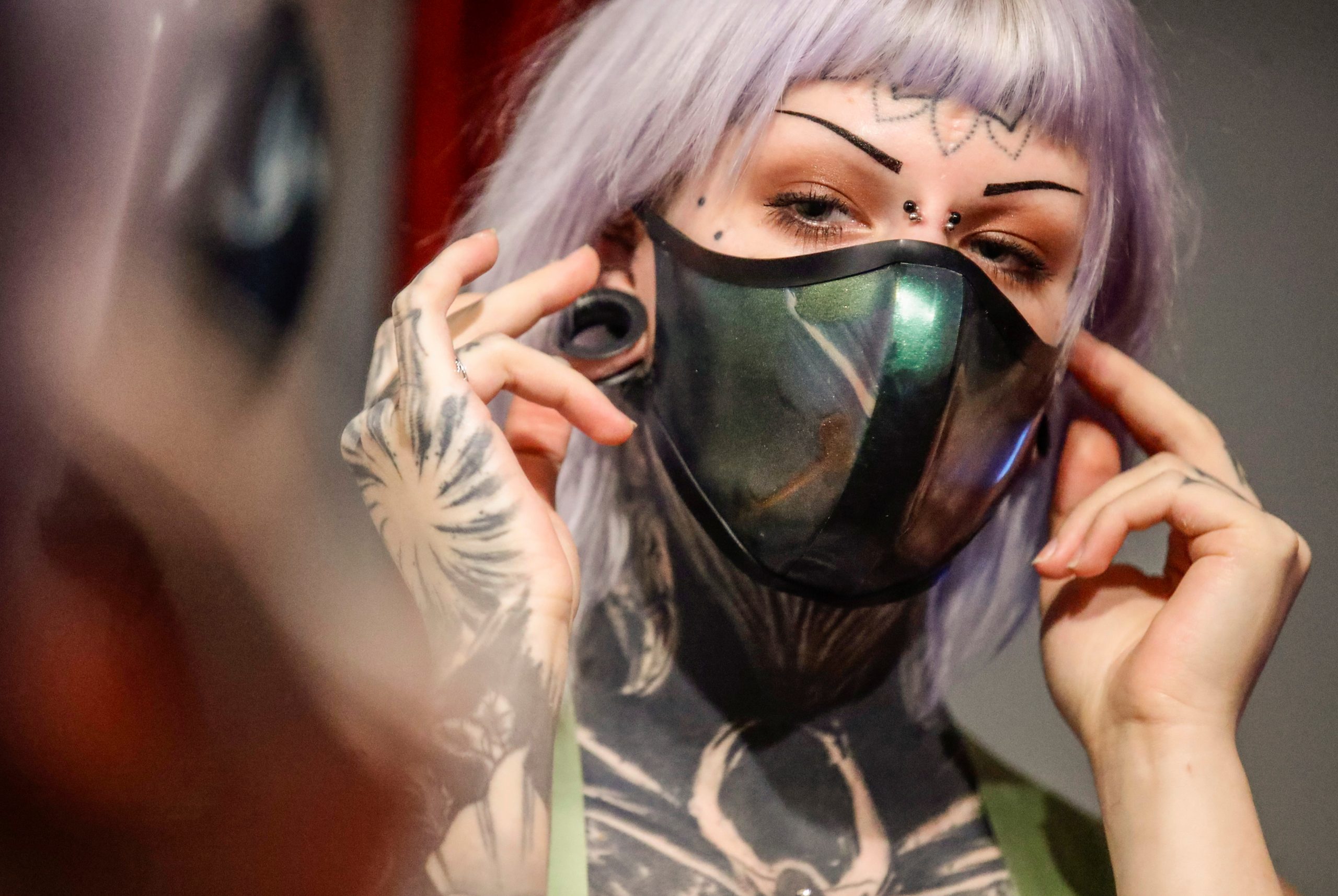 Sina prepares for the reopening of the latex fashion shop Savage Wear as the coronavirus disease (COVID-19) lockdown measures are eased in Berlin, Germany, March 9, 2021. REUTERS/Hannibal Hanschke