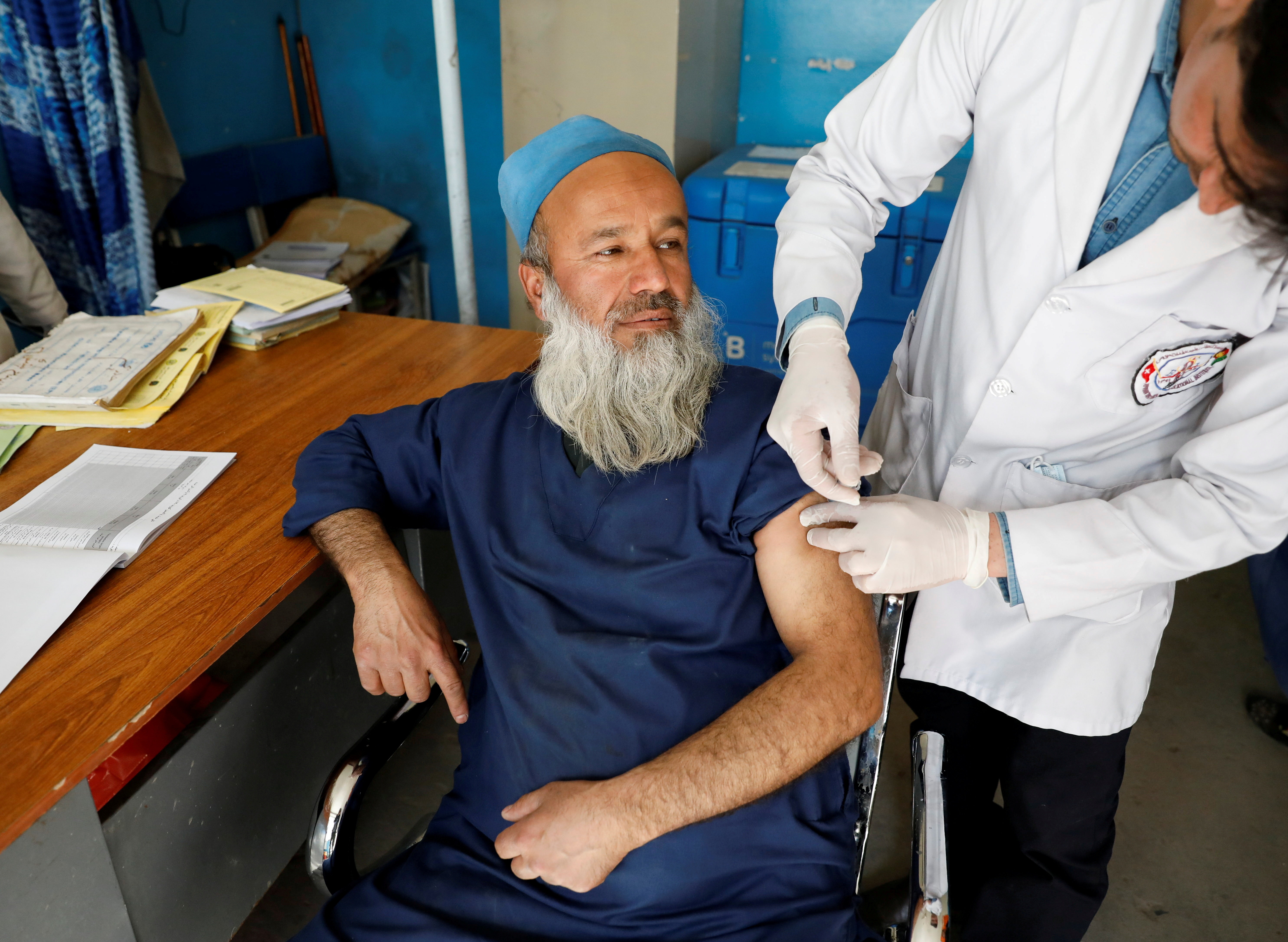 FILE PHOTO: A hospital worker receives the first dose of AstraZeneca's vaccine against the coronavirus disease (COVID-19) at a hospital in Kabul, Afghanistan February 28, 2021. REUTERS/Mohammad Ismail/File Photo