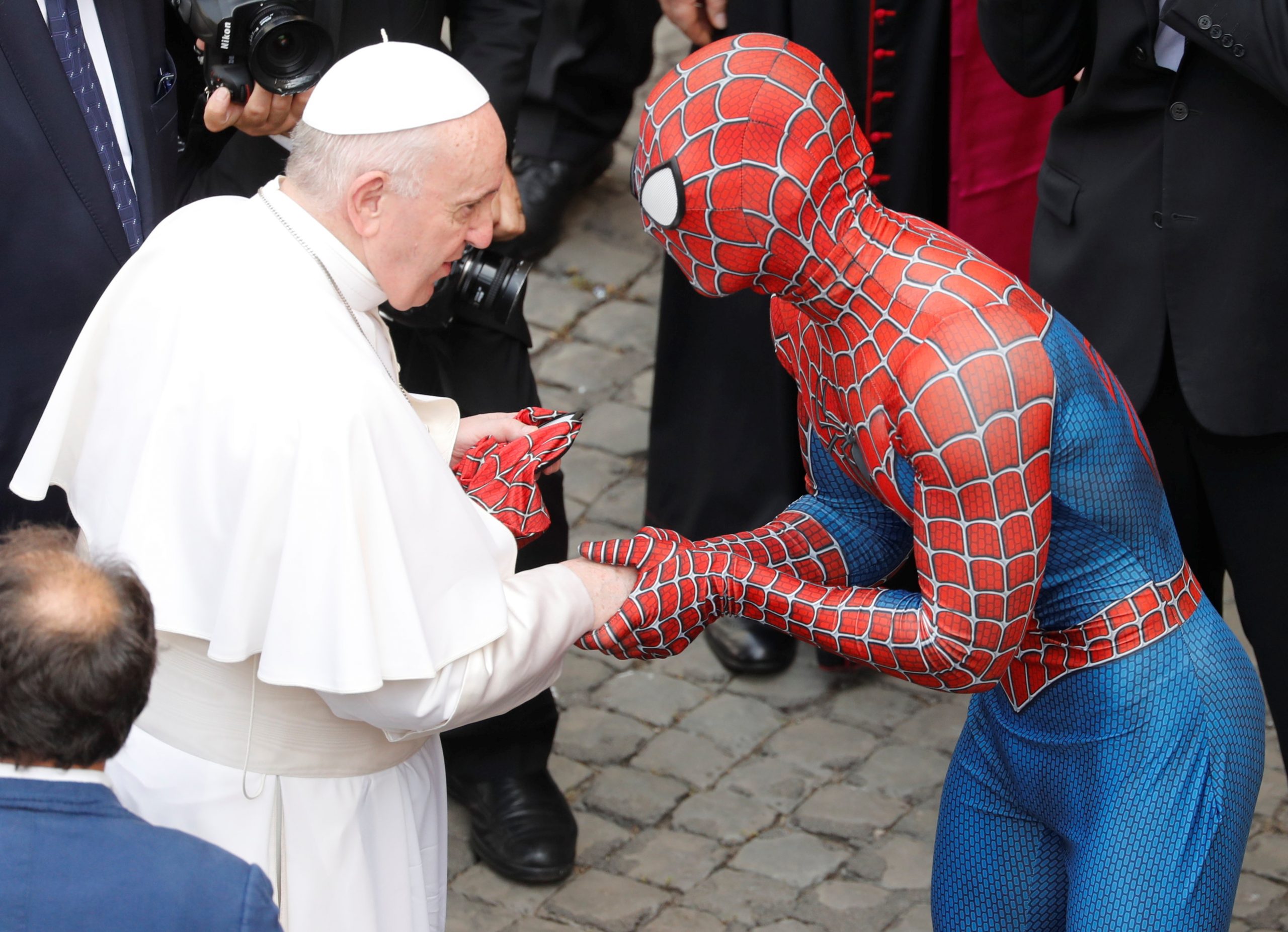 Pope Francis receives a Spiderman mask from a person dressed as Spiderman after the general audience, amid the coronavirus disease (COVID-19) pandemic, at the Vatican, June 23, 2021. REUTERS/Remo Casilli