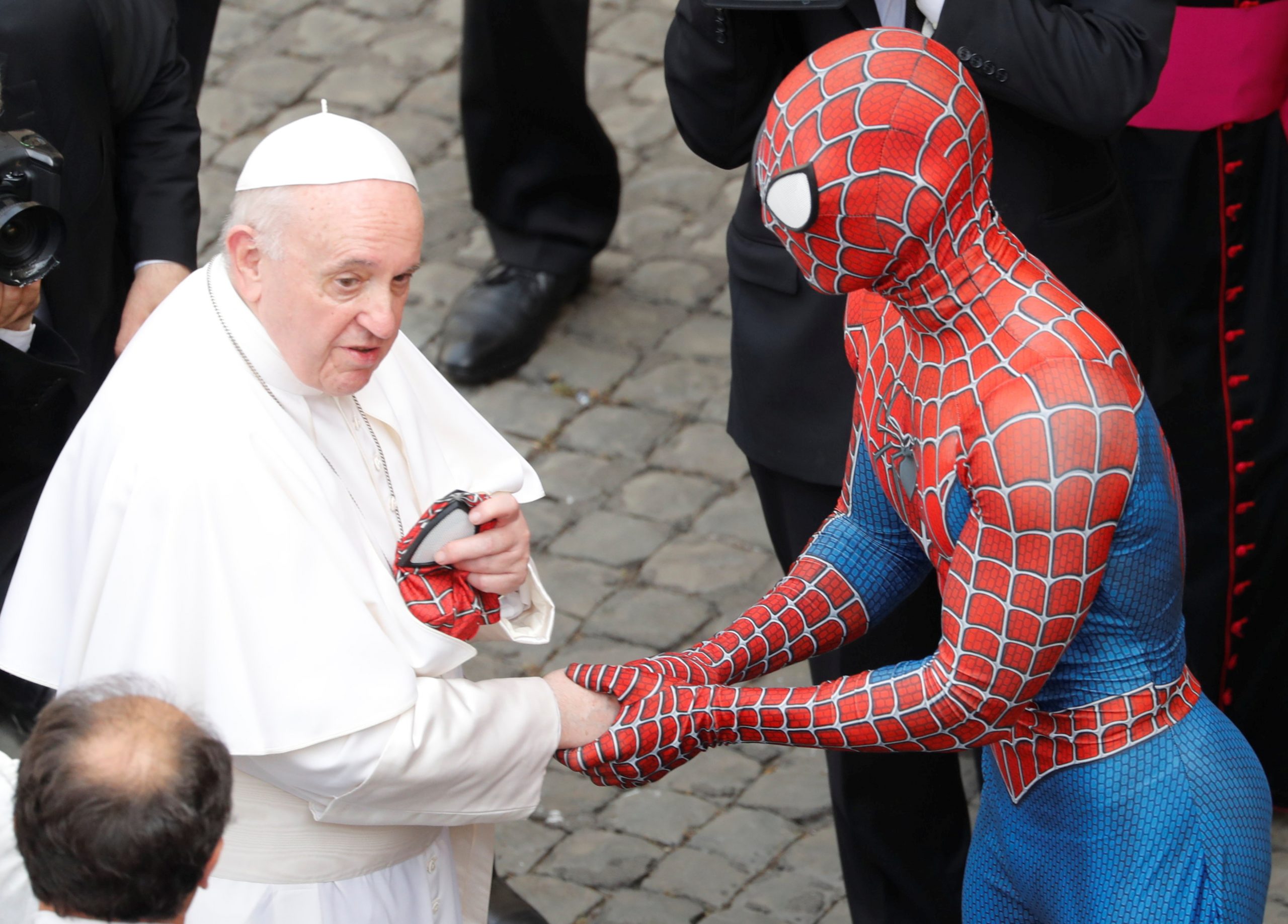 Pope Francis receives a Spiderman mask from a person dressed as Spiderman after the general audience, amid the coronavirus disease (COVID-19) pandemic, at the Vatican, June 23, 2021. REUTERS/Remo Casilli