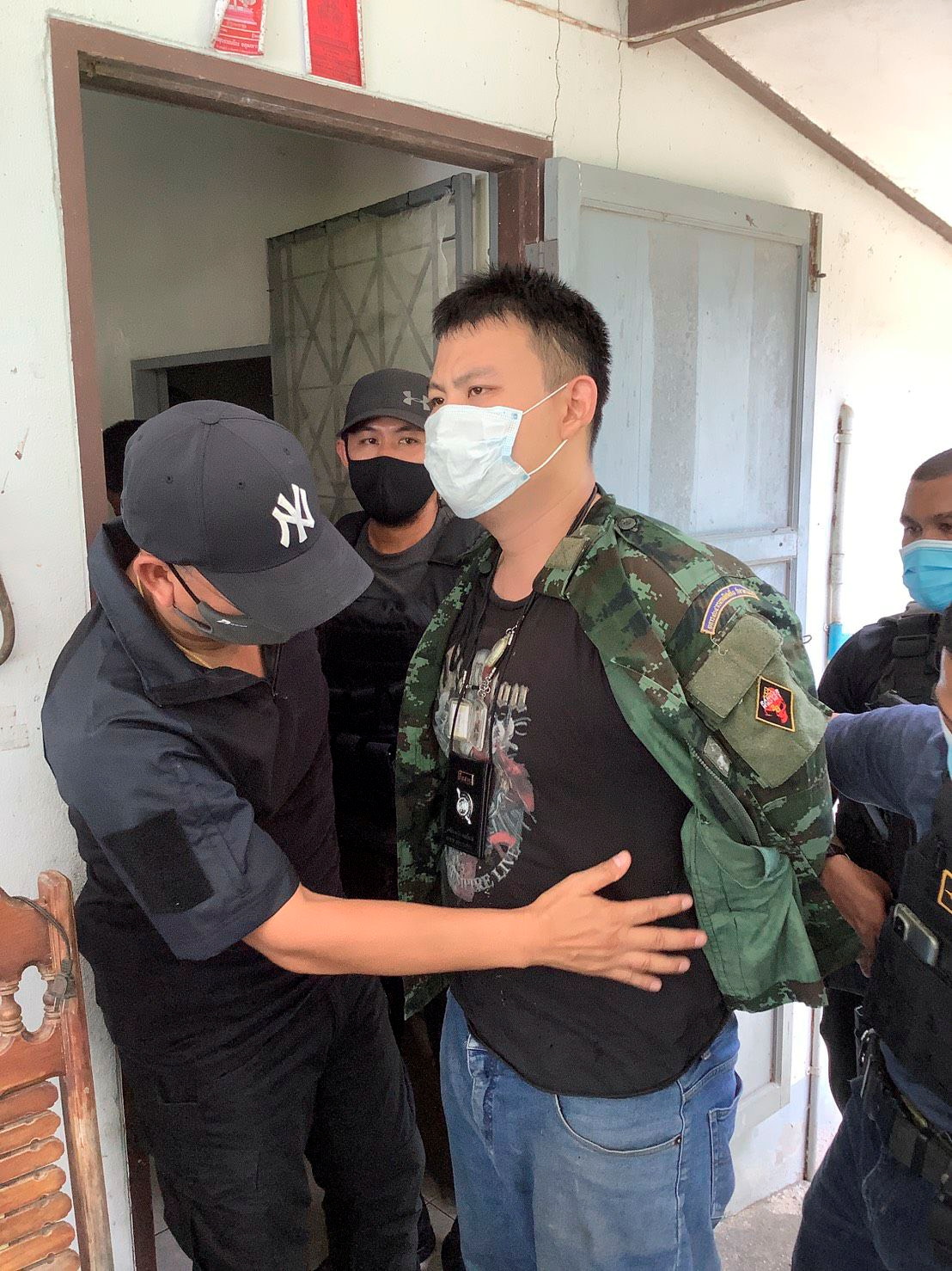 A suspect is arrest by police after a shooting at a coronavirus (COVID-19) field hospital in Ranong, Thailand June 24, 2021. Dailynews via REUTERS  NO RESALES. NO ARCHIVES. THAILAND OUT. NO COMMERCIAL OR EDITORIAL SALES IN THAILAND