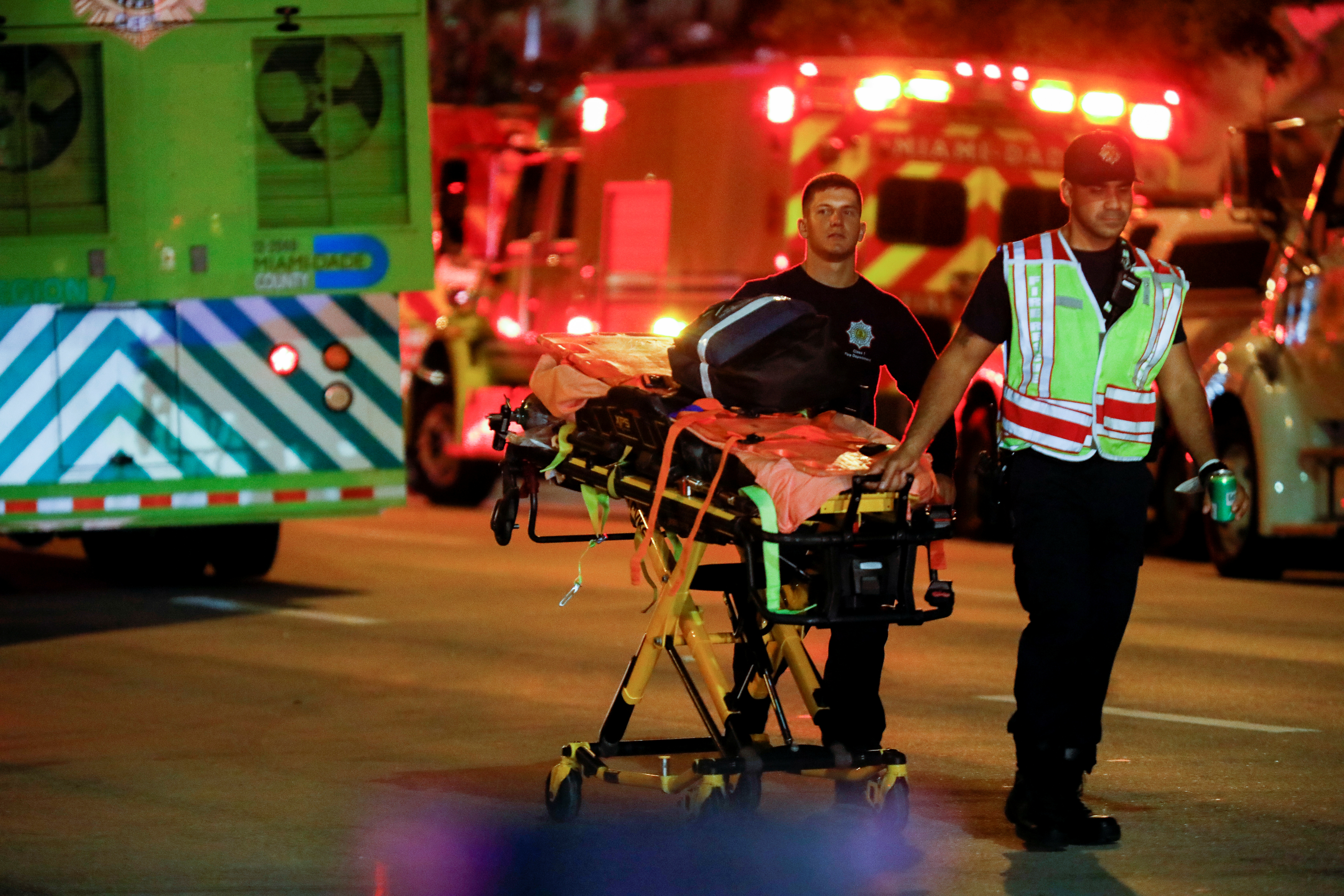 Emergency personnel work at the scene of a partial building collapse in Miami Beach, Florida, U.S., June 24, 2021. REUTERS/Marco Bello
