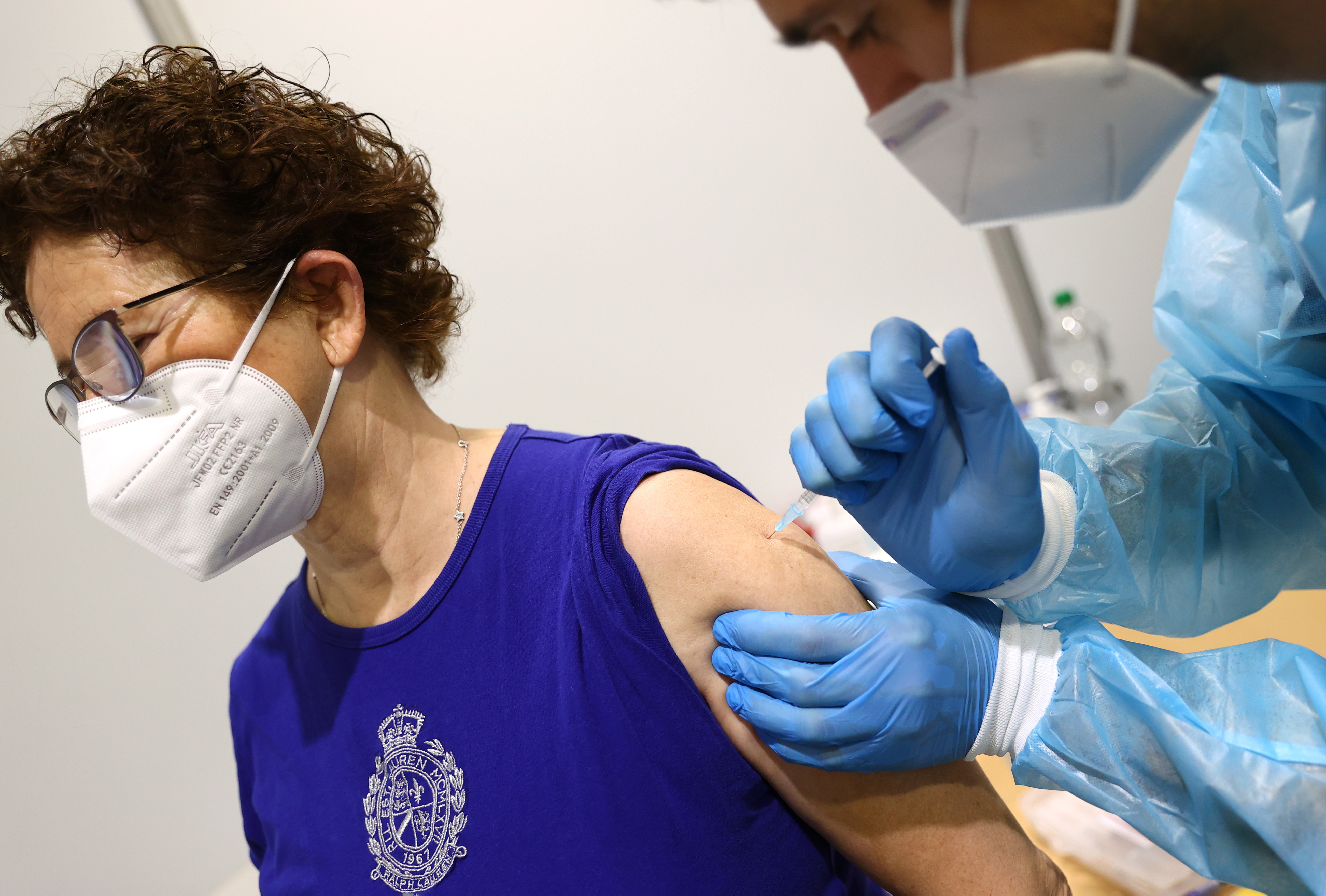 A woman gets her AstraZeneca COVID-19 vaccine at the local vaccination centre as the spread of the coronavirus disease (COVID-19) continues in Hagen, Germany, March 19, 2021.  REUTERS/Kai Pfaffenbach