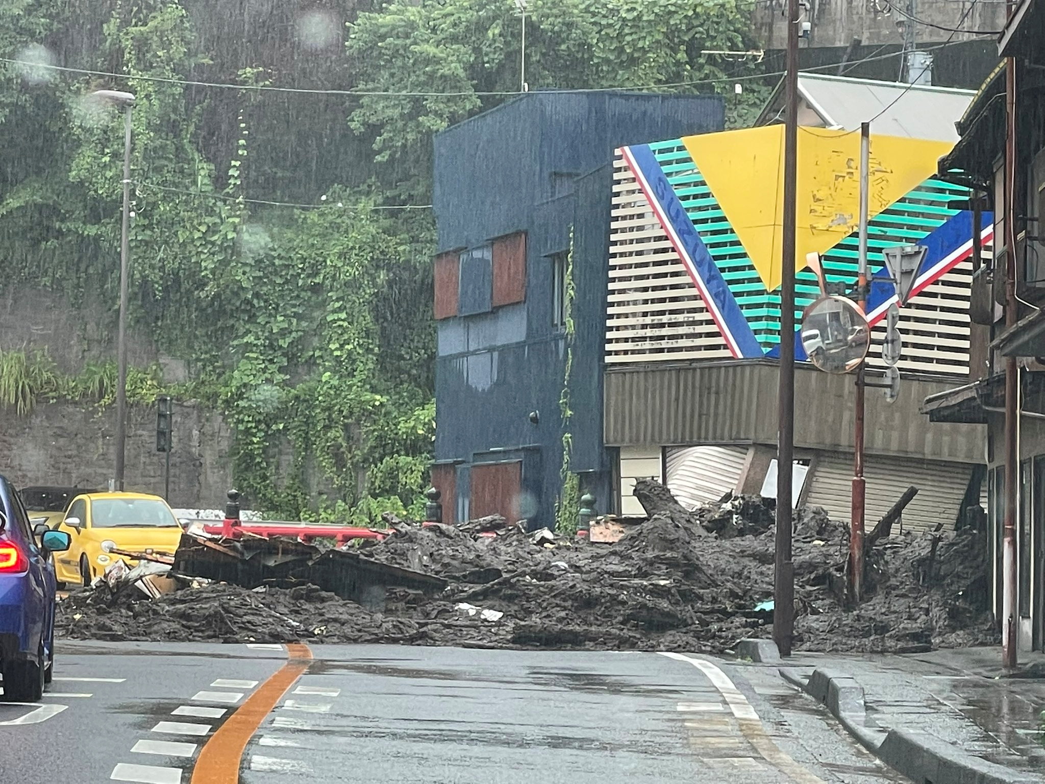 Debris covers road after heavy rainfall in Izusan
