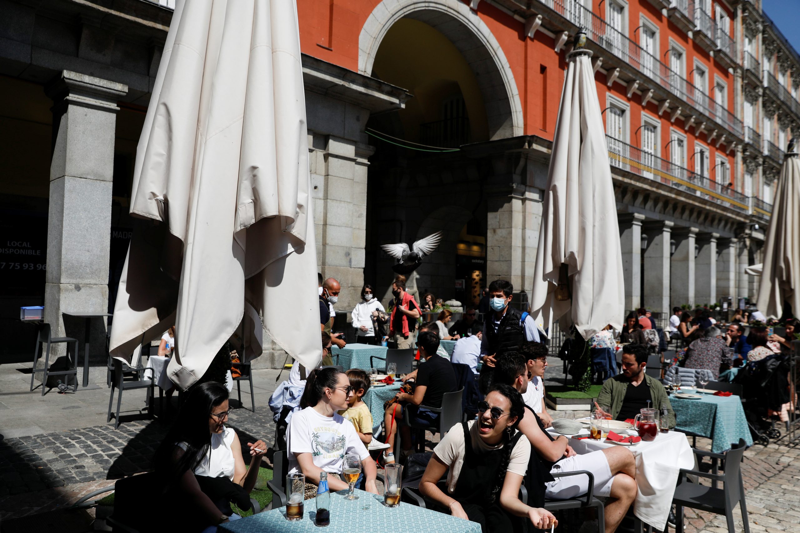 Madrid
A pigeon flies over as people sit at a terrace, amid the coronavirus disease (COVID-19) pandemic, at Plaza Mayor square, in Madrid, Spain, April 4, 2021. REUTERS/Susana Vera
