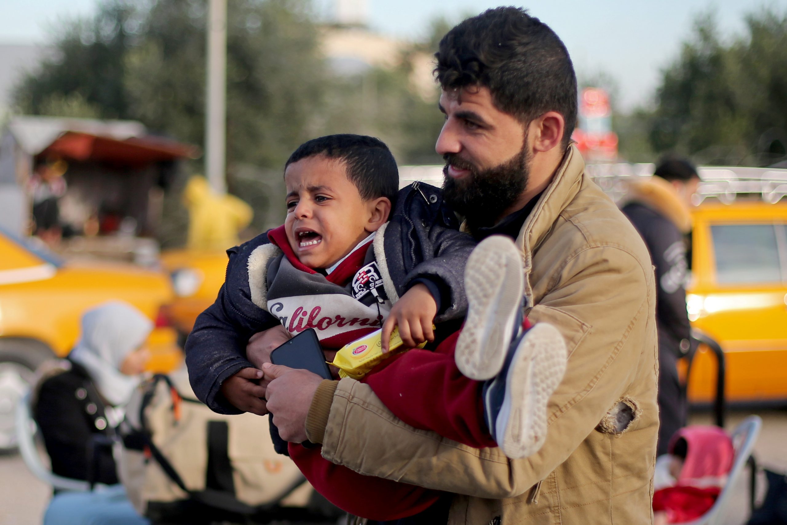 A Palestinian boy cries as he waits to leave Rafah border crossing after it was opened by Egyptian authorities, in the southern Gaza Strip February 9, 2021.  REUTERS/Ibraheem Abu Mustafa