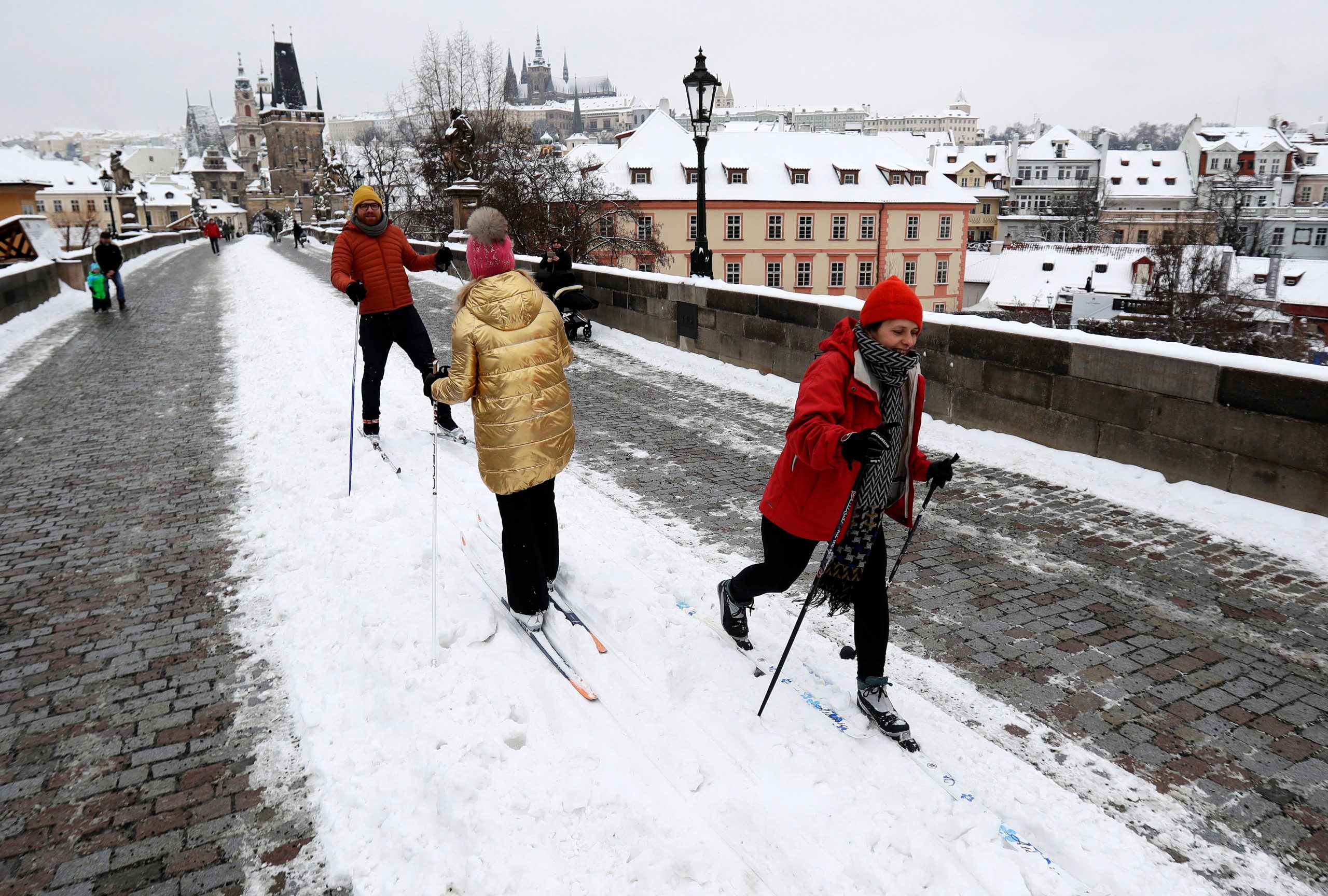 People cross-country ski across the medieval Charles Bridge in Prague, Czech Republic, February 9, 2021.  REUTERS/David W Cerny