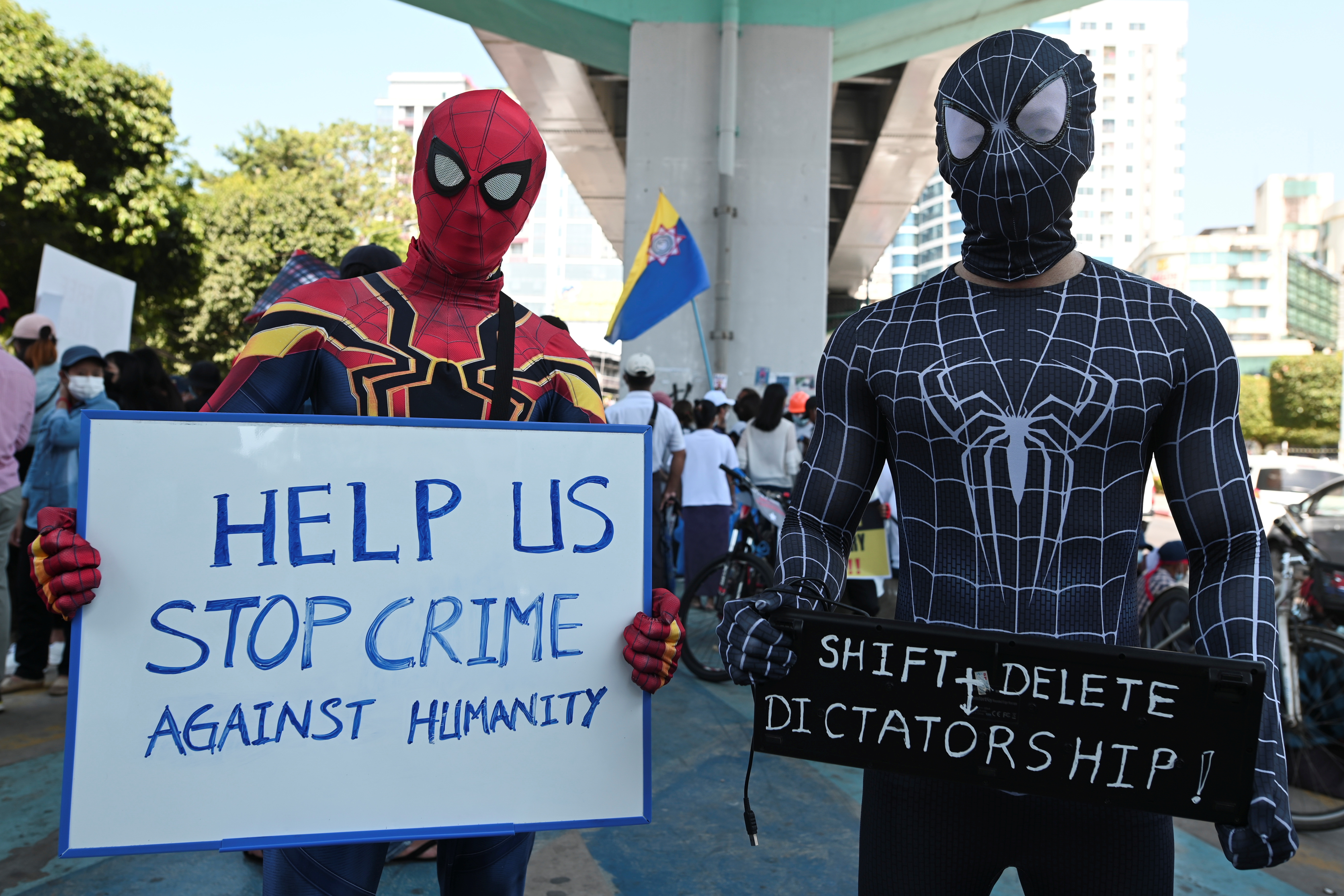 Demonstrators hold up signs during a protest against the military coup in Yangon, Myanmar, February 13, 2021. REUTERS/Stringer
