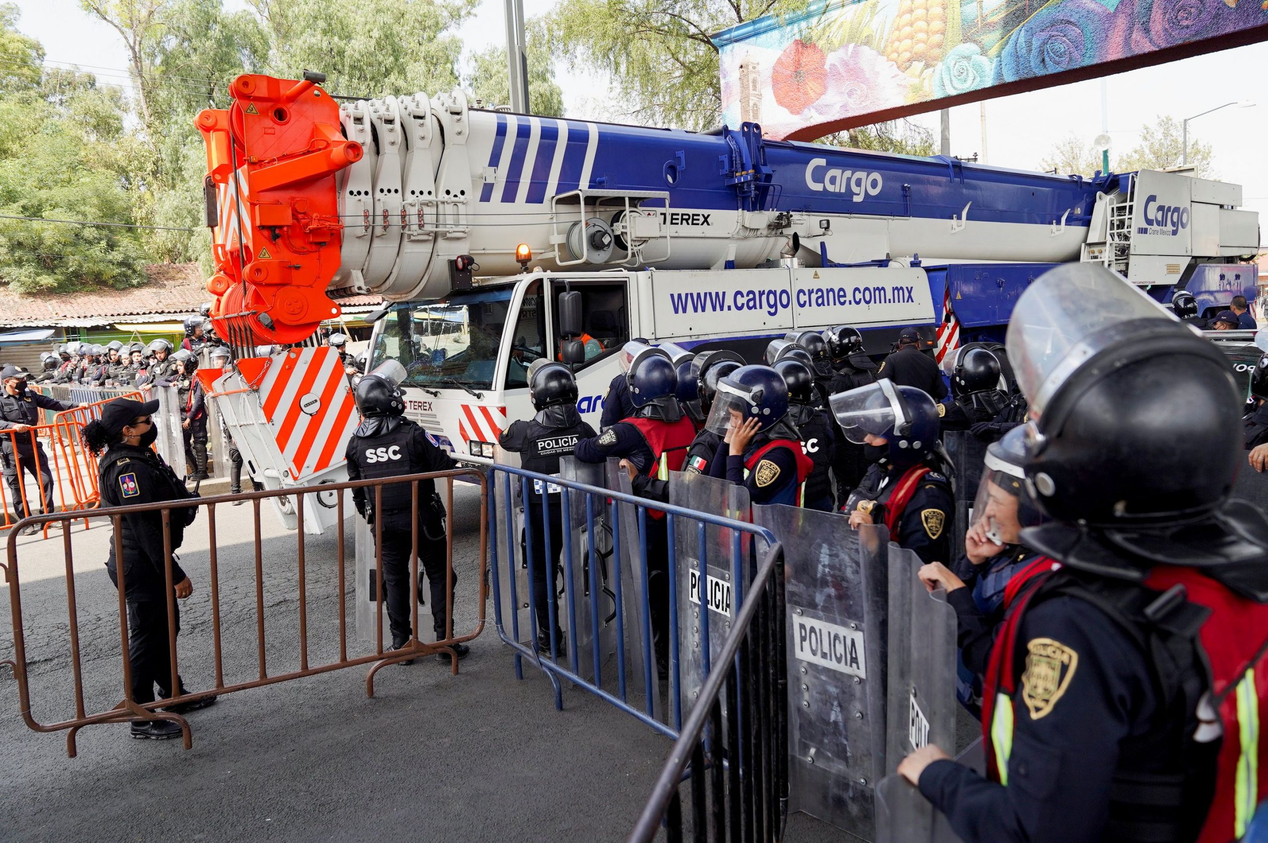 A crane exits the site of an accident where an overpass of the metro partially collapsed with train cars on it, in Mexico City, Mexico May 4, 2021. REUTERS/Toya Sarno Jordan
