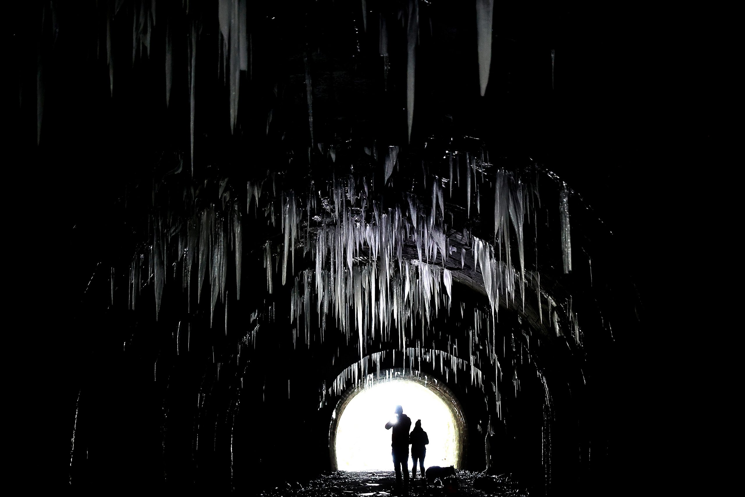 People photograph the icicles hanging from the roof of Hopton Tunnel, near the village of Hopton, Derbyshire, Britain, February 14, 2021.REUTERS/Carl Recine