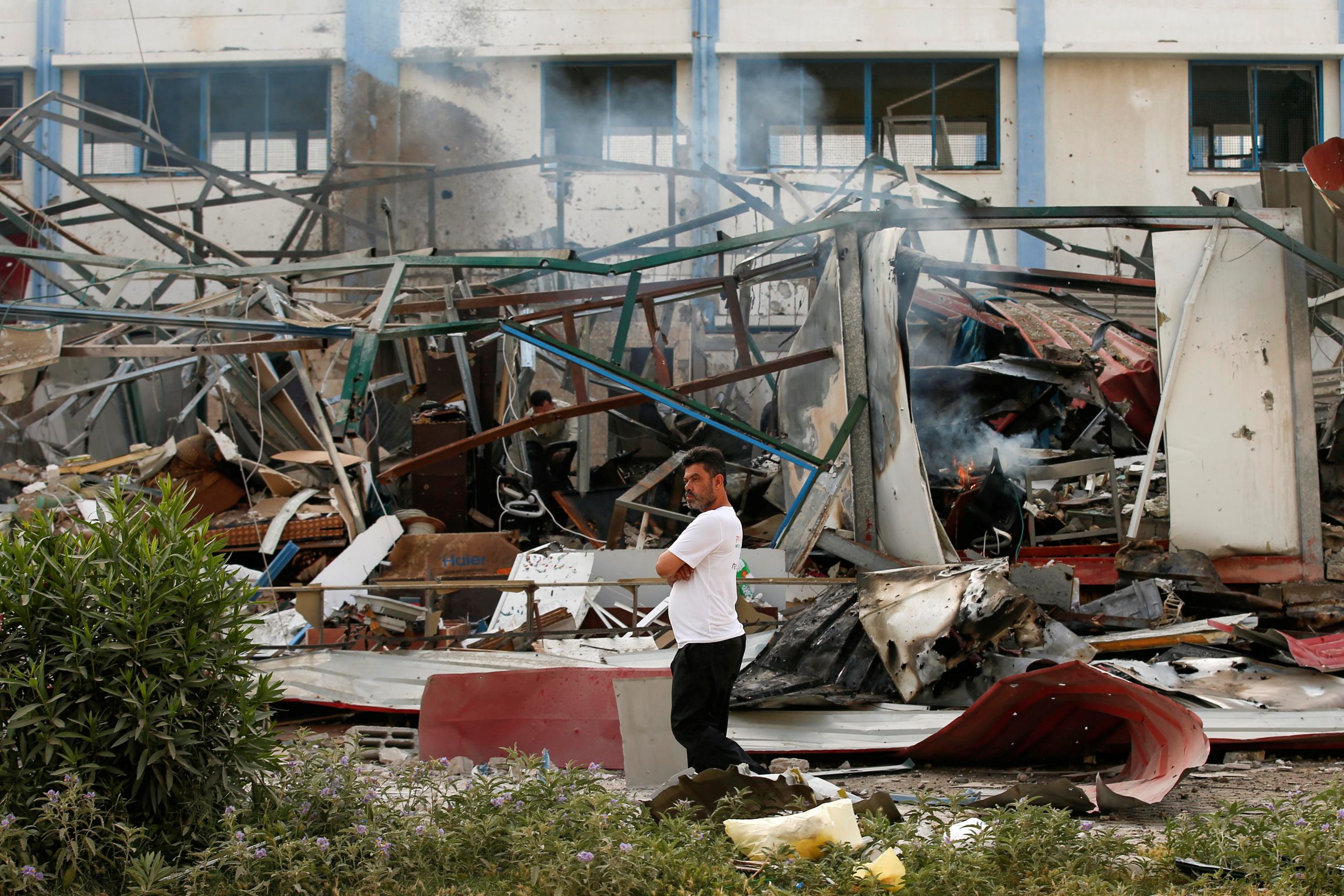 A Palestinian man looks on as he stands at the site of an Israeli air strike amid a flare-up of Israeli-Palestinian violence, in Gaza City May 11, 2021. REUTERS/Suhaib Salem