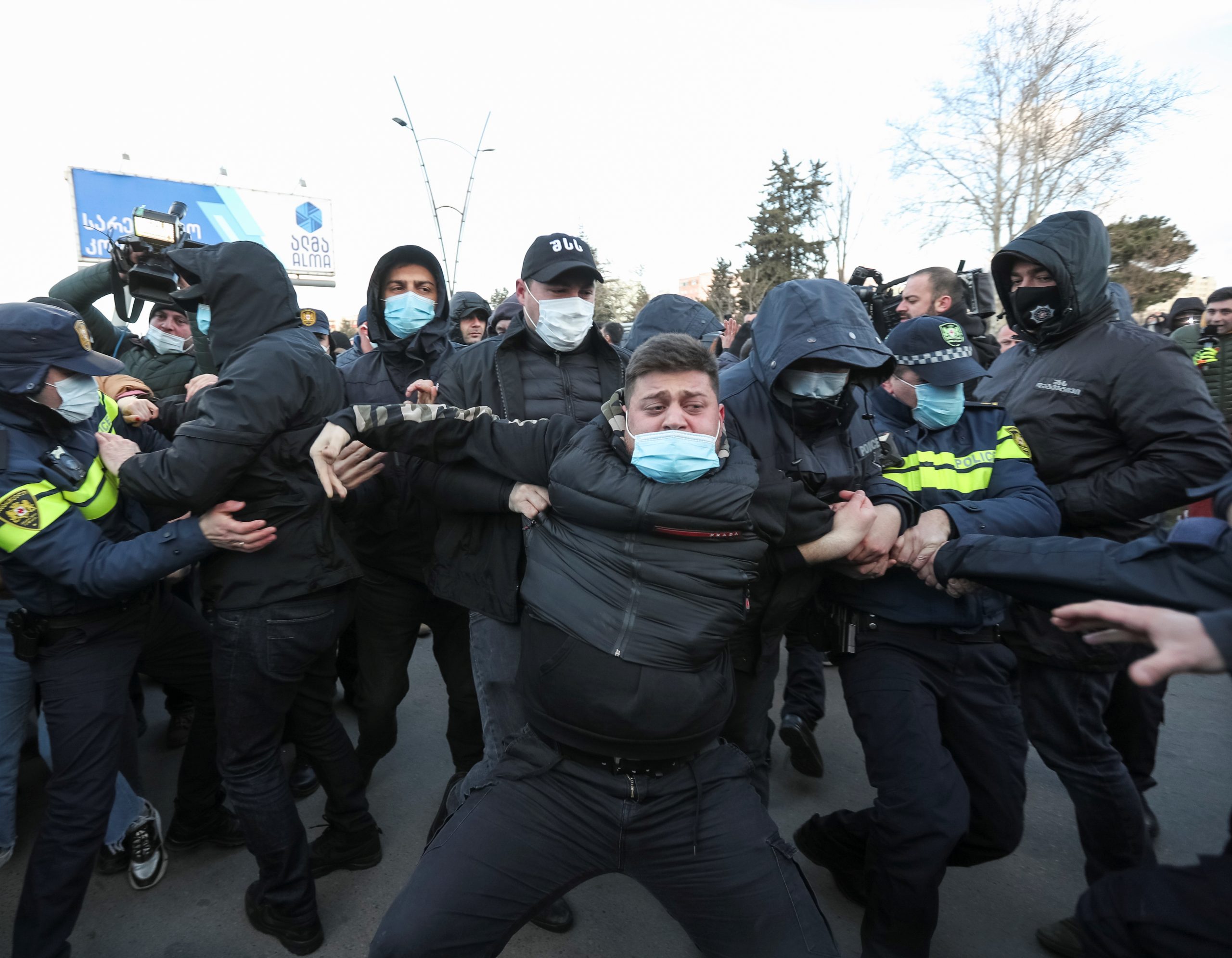 Georgian law enforcement officers detain an opposition supporter after storming the United National Movement (UNM) opposition party office in Tbilisi, Georgia February 23, 2021. REUTERS/Irakli Gedenidze