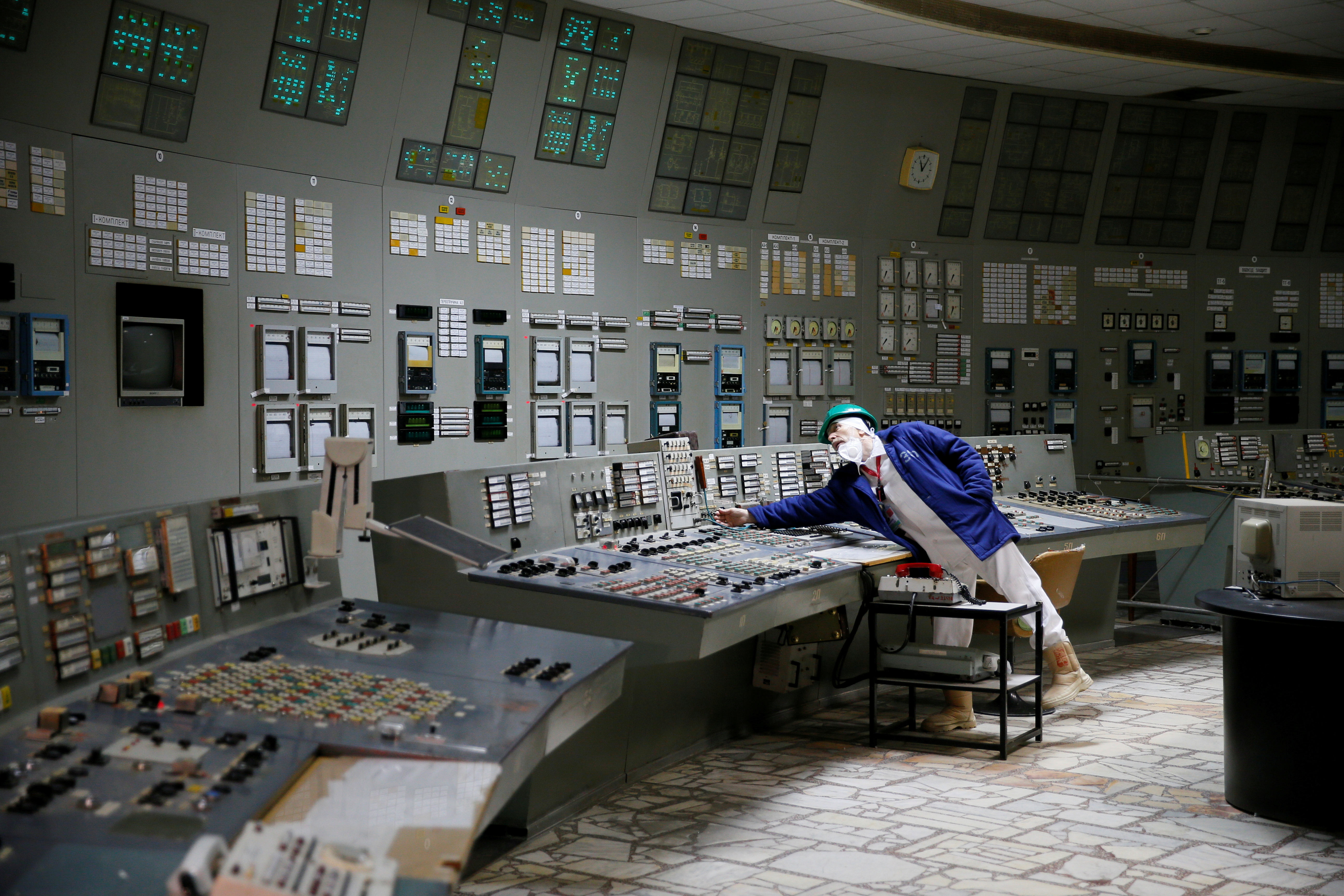 FILE PHOTO: An employee is seen in a control centre of one of the stopped reactors at the Chernobyl Nuclear Power Plant in Chernobyl, Ukraine March 25, 2021. REUTERS/Gleb Garanich/File Photo